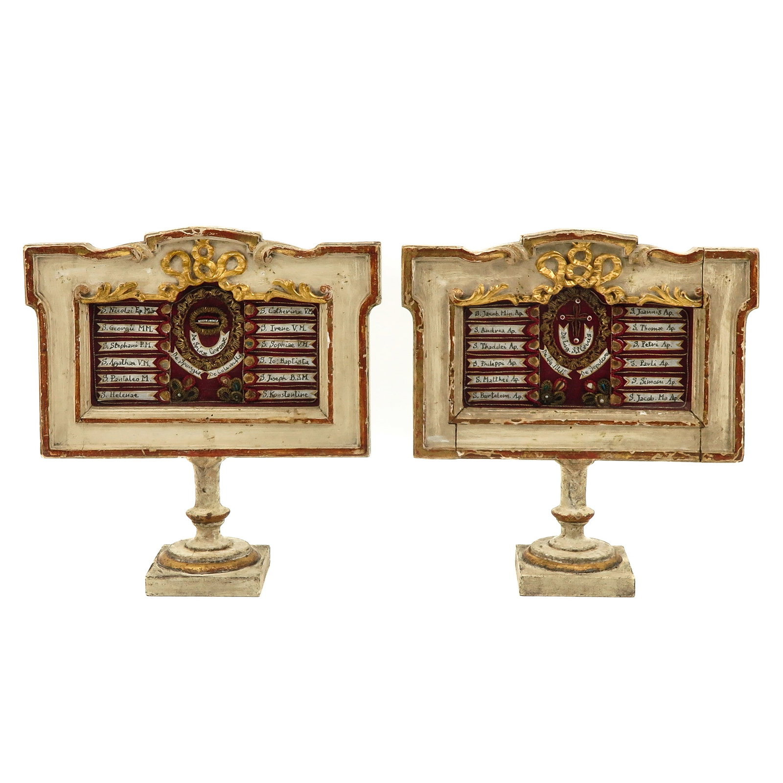 An Exceptional Pair of Relic Holders: reliquaries, in carved, lacquered and gilded wood, interior on burgundy silk, between decorations and pearls in gold filigree, the relics are provided with labels outlined in gold, closed on the back 