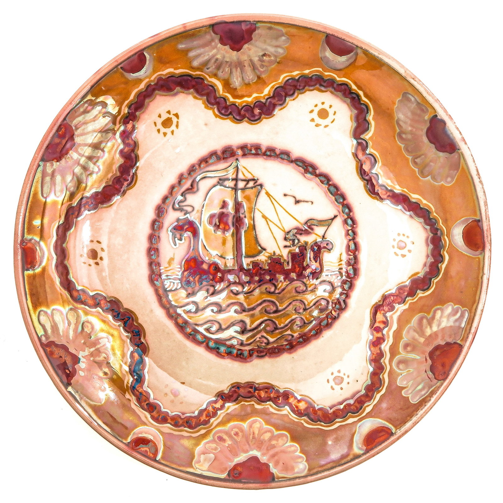 A Porceleyne Fles Plate: by de Porceleyne Fles, Oosterloo, Delft, ca. 1930, with a representation of a stylized sailing ship, flanked by sea monsters, on wavy water with birds above it, 22 cm. in diameter.