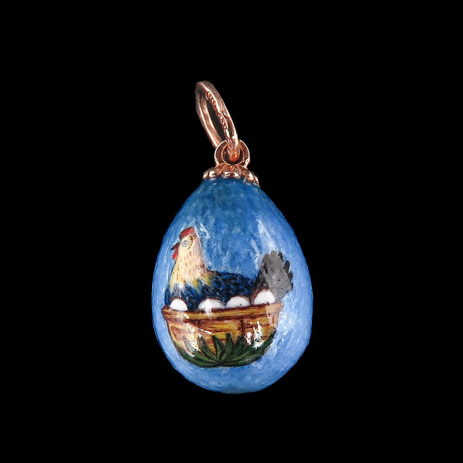 An Enamel Egg Pendant: enamel egg with representation of a rooster in a basket, in gold mounting, length 20 mm.