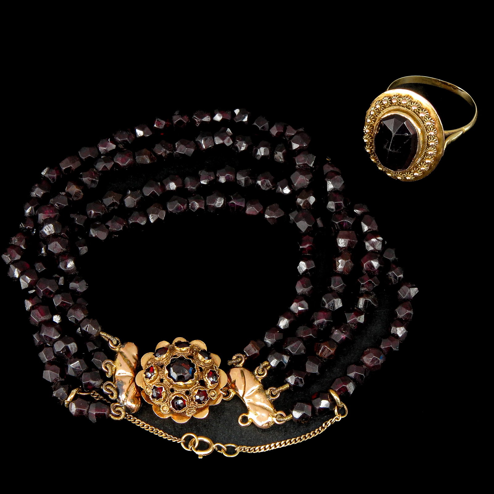 A Bracelet and a Ring: consisting of garnet bracelet with 14KG clasp and 14 KG ring with garnet, ring size 18