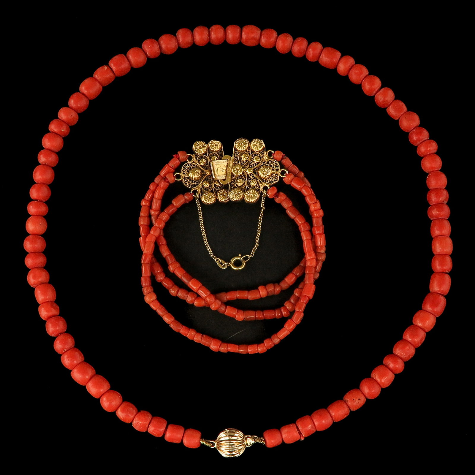 A Red Coral Necklace and Bracelet: diameter beads 3 - 8 mm., total weight 51 grams, both with 14KG clasps