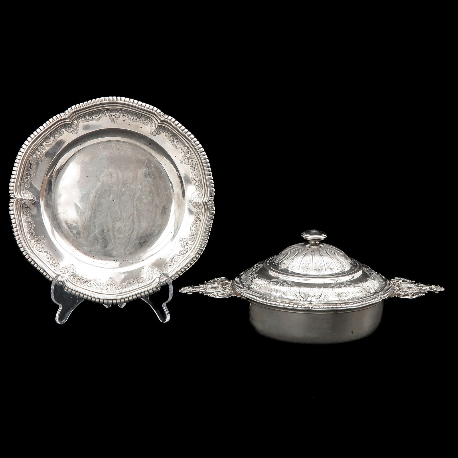 A Silver Tureen: silver, 19th century, France, oval tureen with lid, richly decorated with engraved and embossed motifs, together with matching saucer. Delivered in original velvet presentation box marked Mellerio dit
