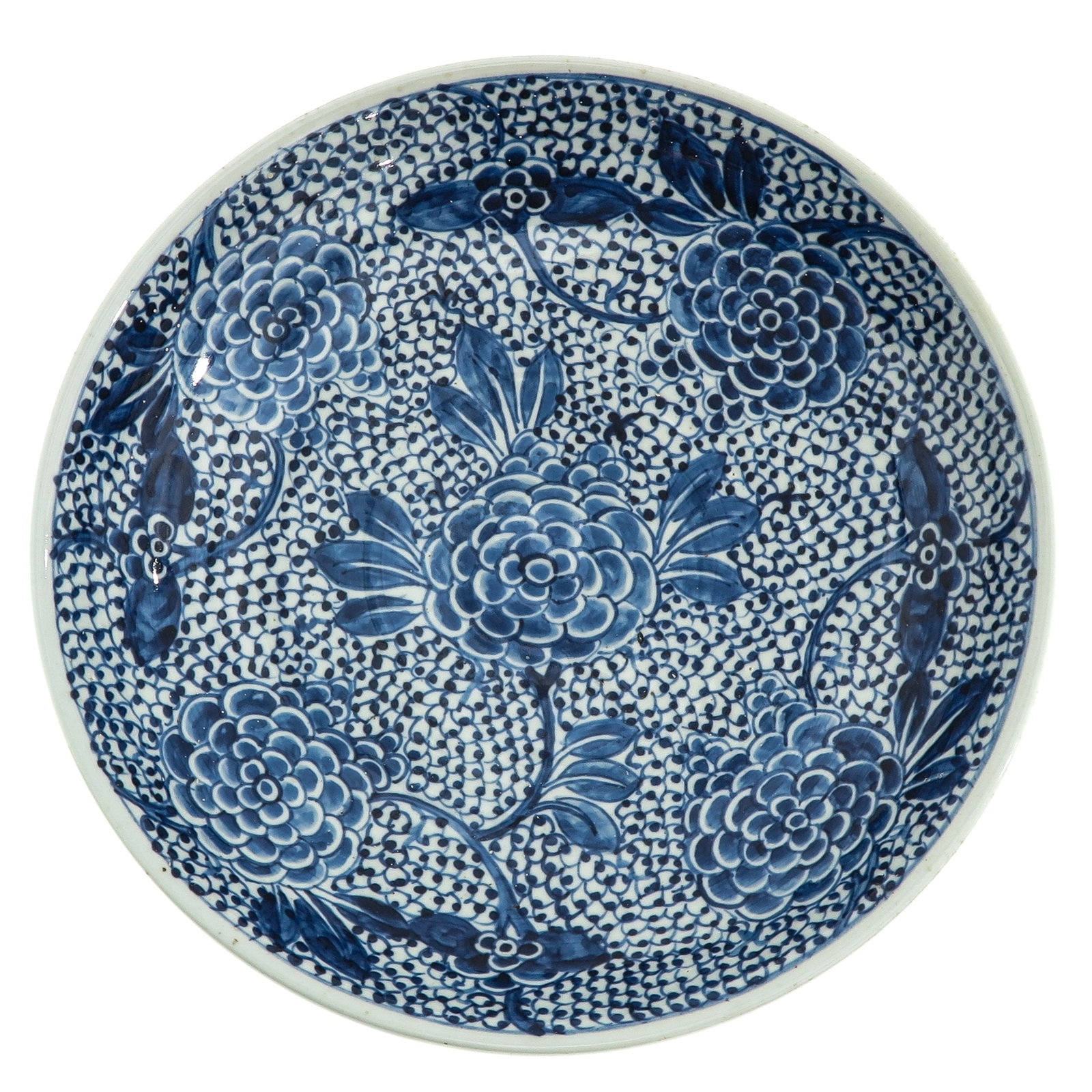 A Blue and White Charger: Featuring a floral ground of peony blooms with scrolling foliage, 35 cm. in diameter.