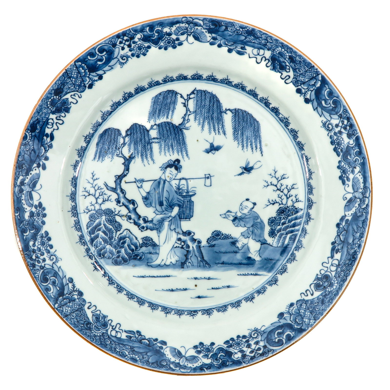A Blue and White Charger: Depicting a garden scene with Chinese figures, floral border, 18th Century, 31 cm. in diameter,