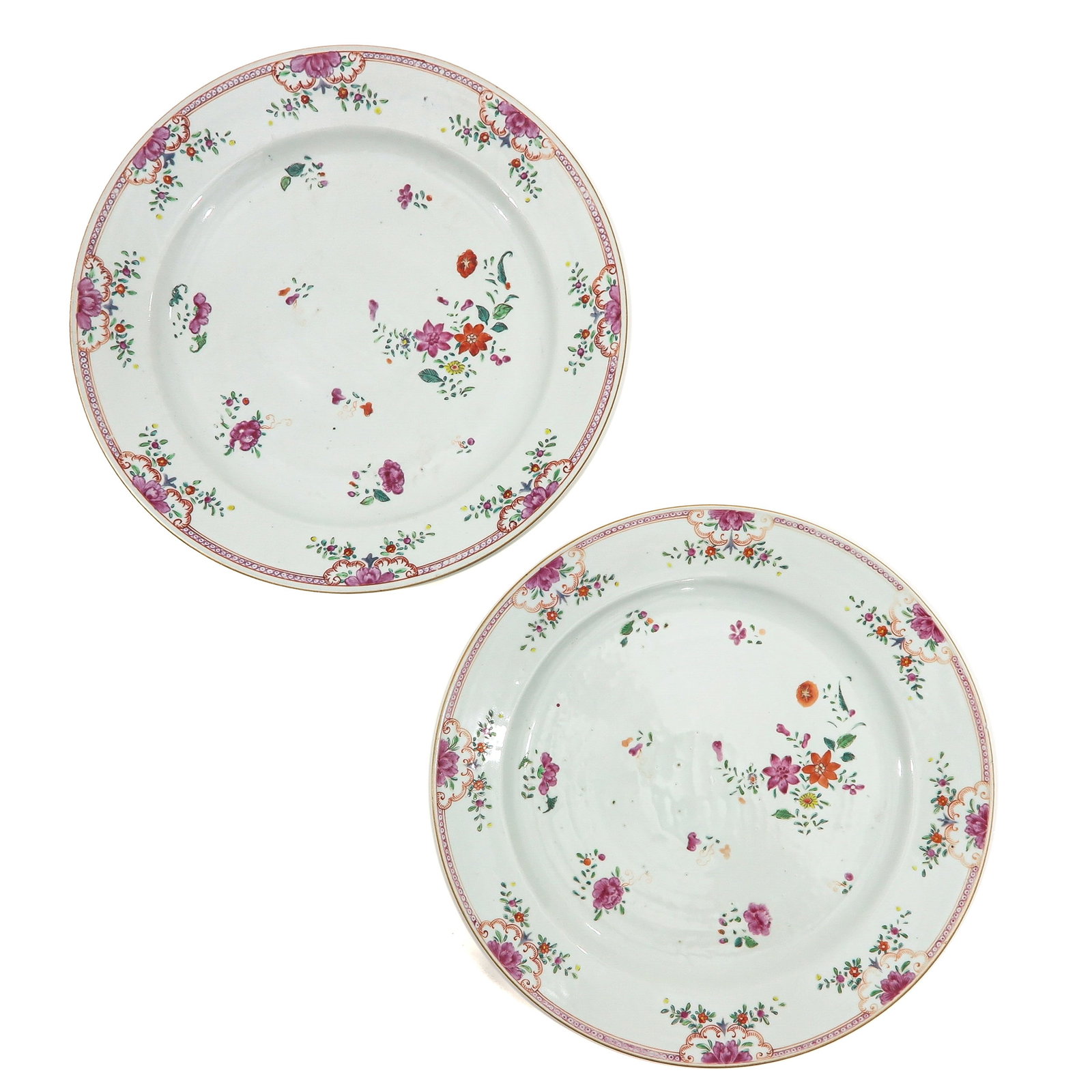 A Pair of Famille Rose Chargers: Decorated with scattered floral sprays and a border of penoies and scrollwork, 18th Century, 37 cm. in diameter.