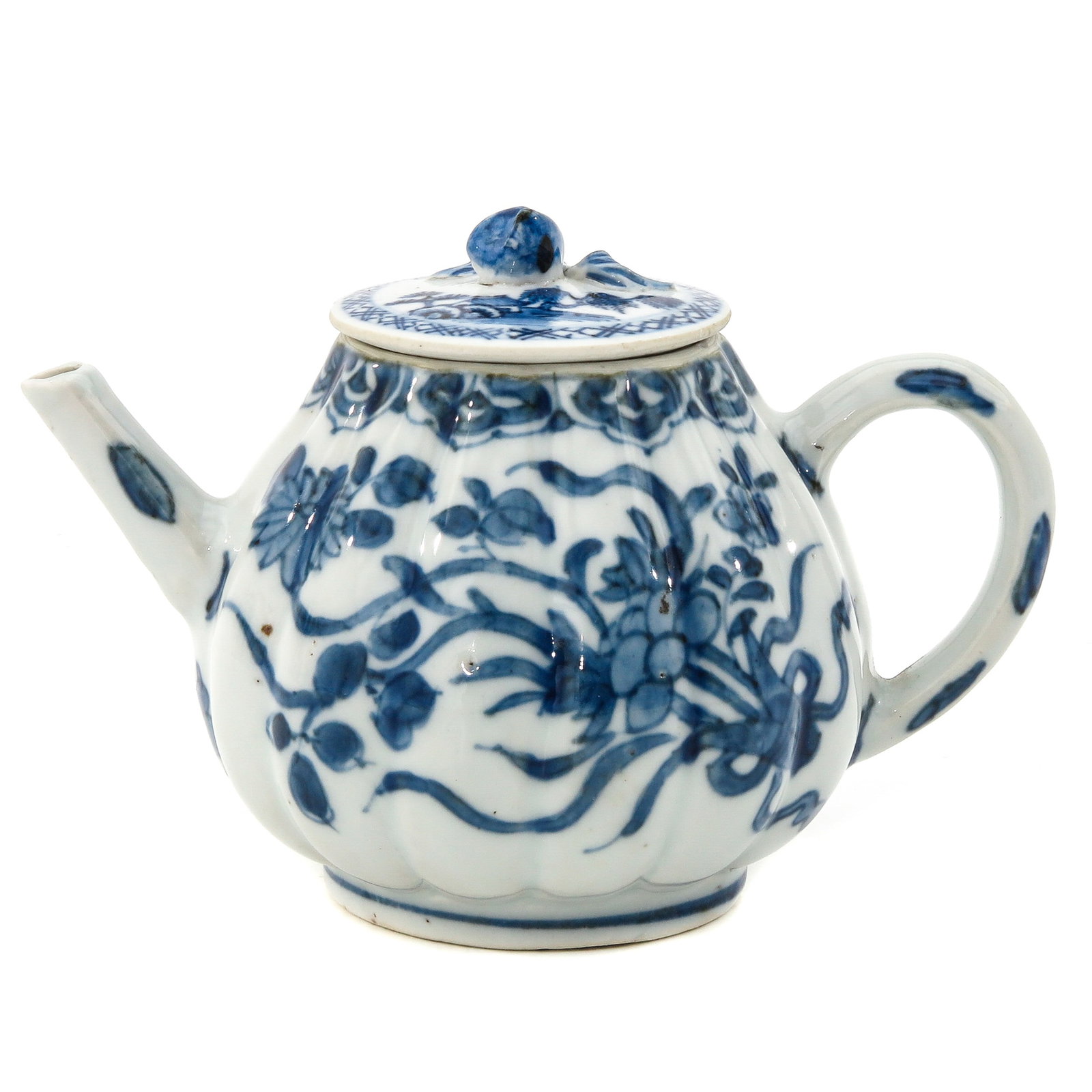 A Blue and White Teapot: Floral decoration with domed lid with bud shaped finial, 18th Century, 10 cm. tall.