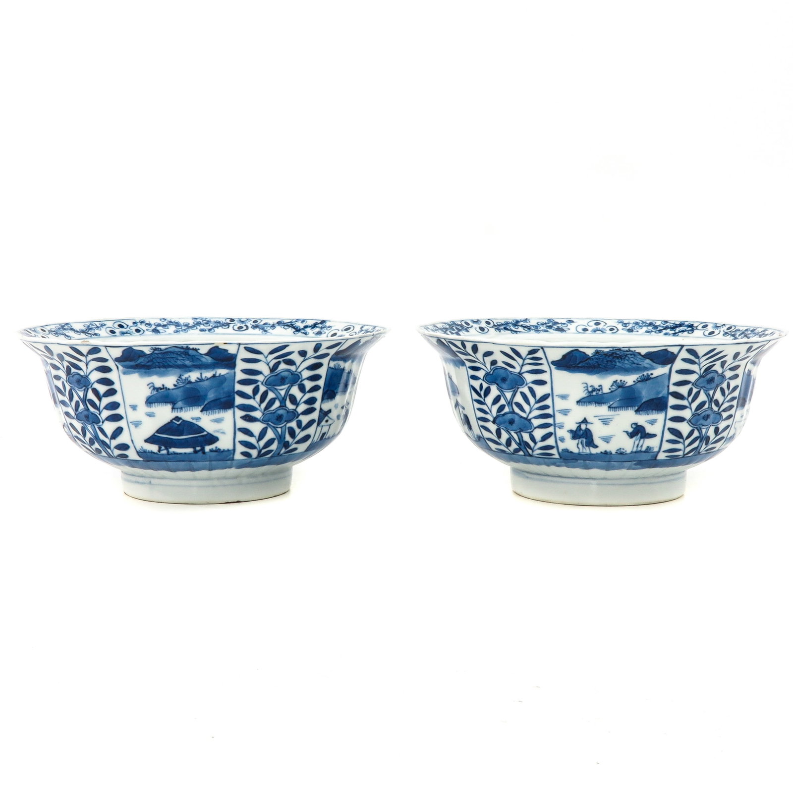 A Pair of Blue and White Bowls: Alternating panels with floral decors, 18th Century, 18 cm. in diameter, fritting.
