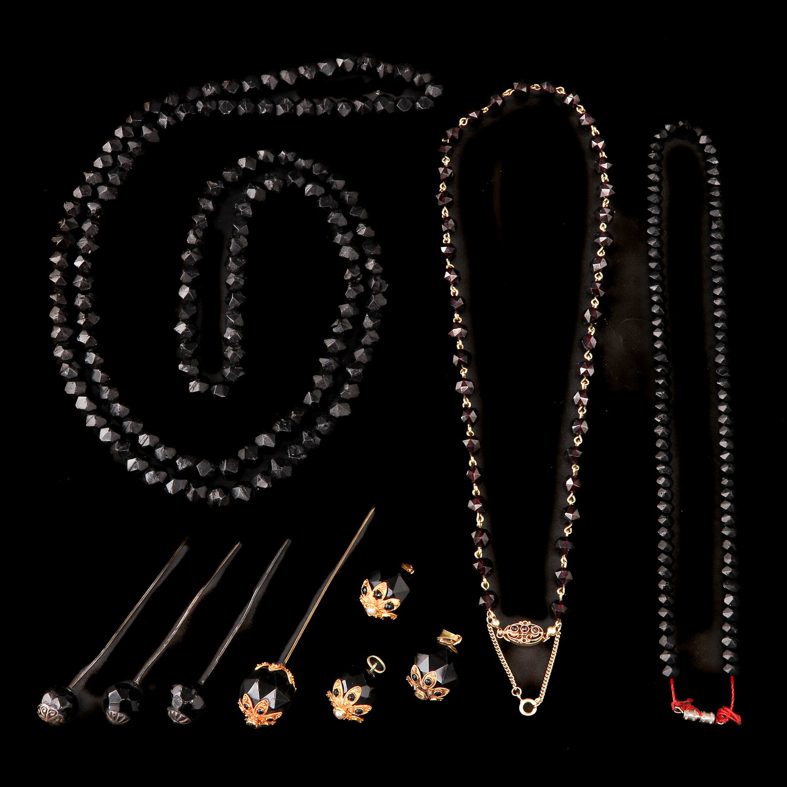 A Group of Garnet Jewelry: Garnet jewelry: including three necklaces and tie pins, partly in 14-karat gold, longest 16 cm.