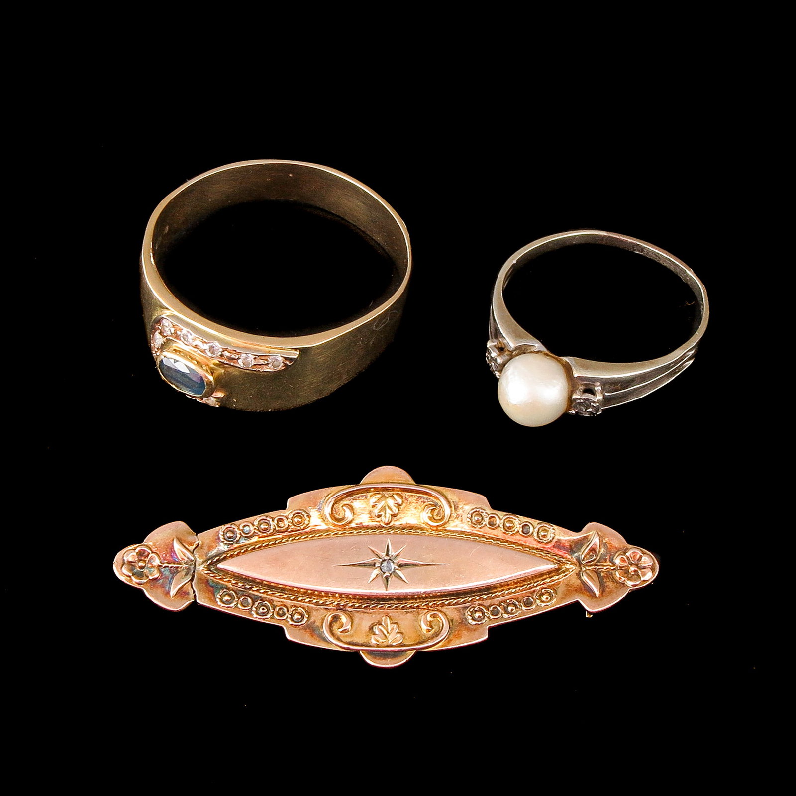A Group of Jewelry: Jewelry, including a pearl ring, a sapphire ring, and a brooch, in 9 and 18-karat gold, ring sizes 18 and 23