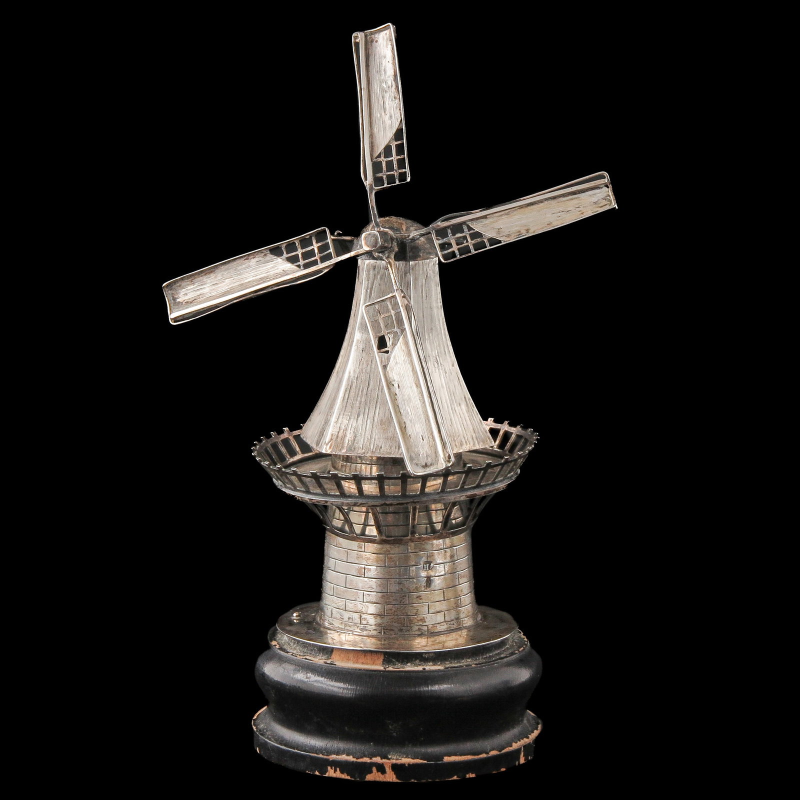 A Silver Windmill: Silver, on a wooden base, height 16 cm.