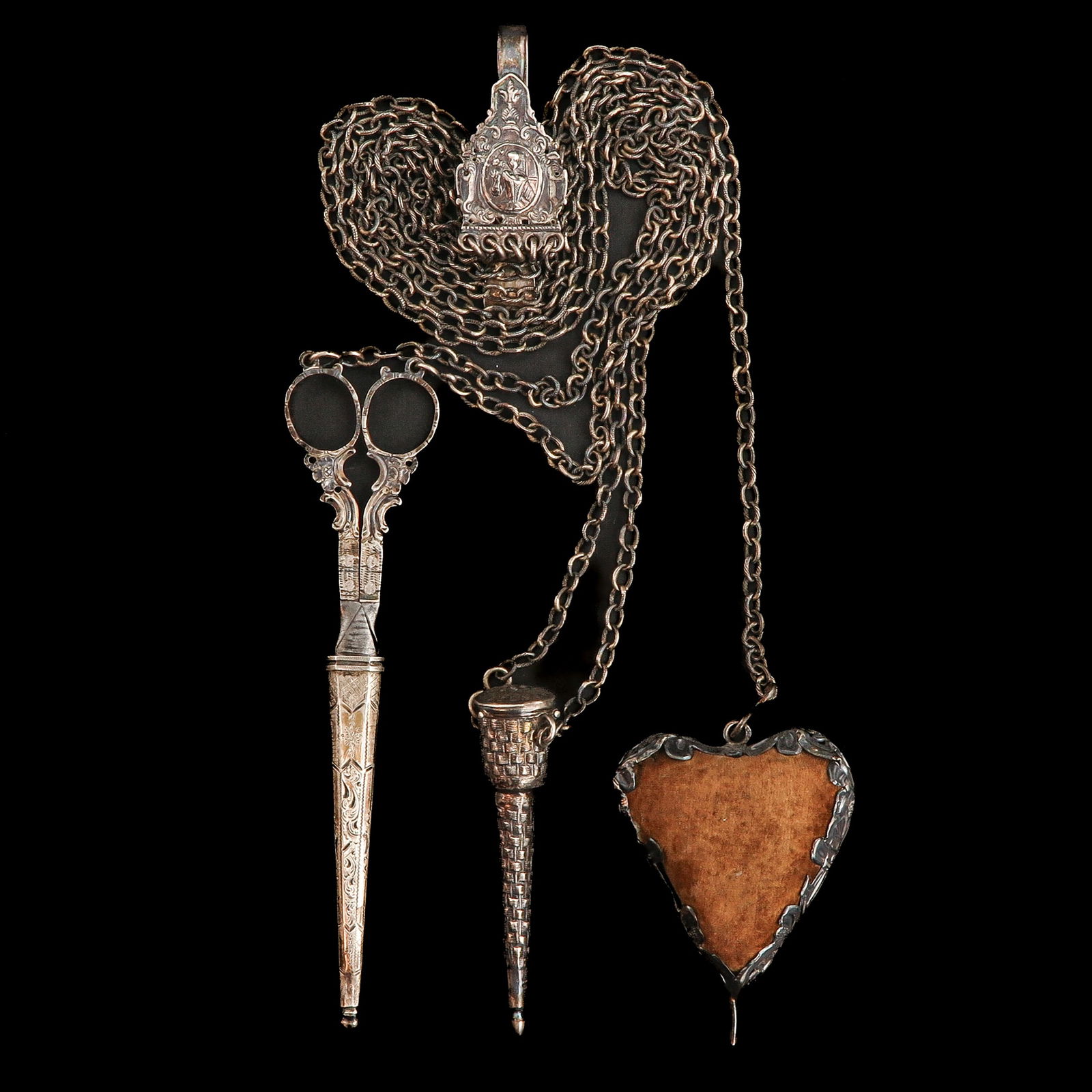 A Silver Chatelaine: Silver, with pincushion, needle cases, and scissors, 18th century, length 75 cm.