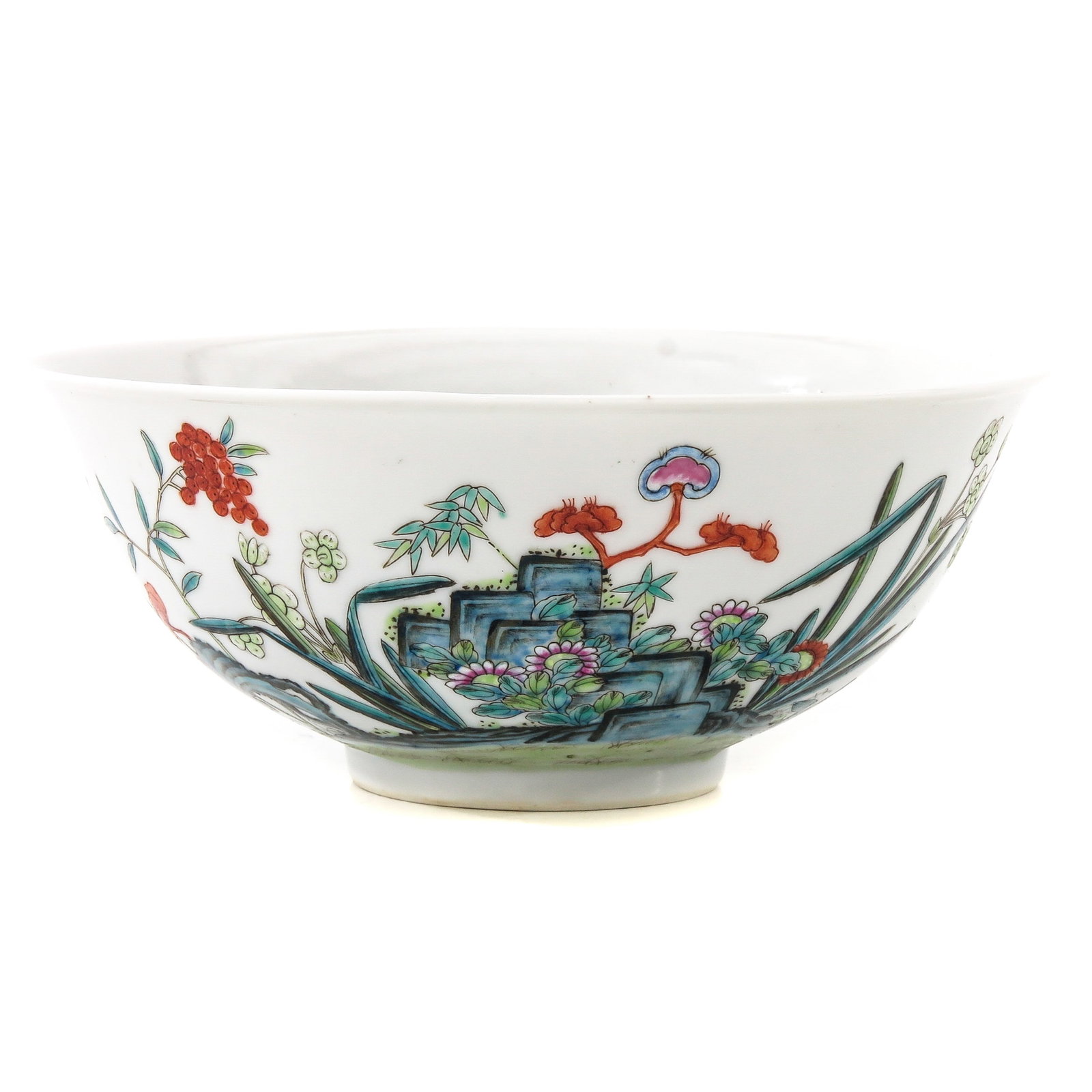 A Famille Rose Bowl: Depicting flowers in a garden with rocks, Qianlong mark, 16 cm. in diameter.