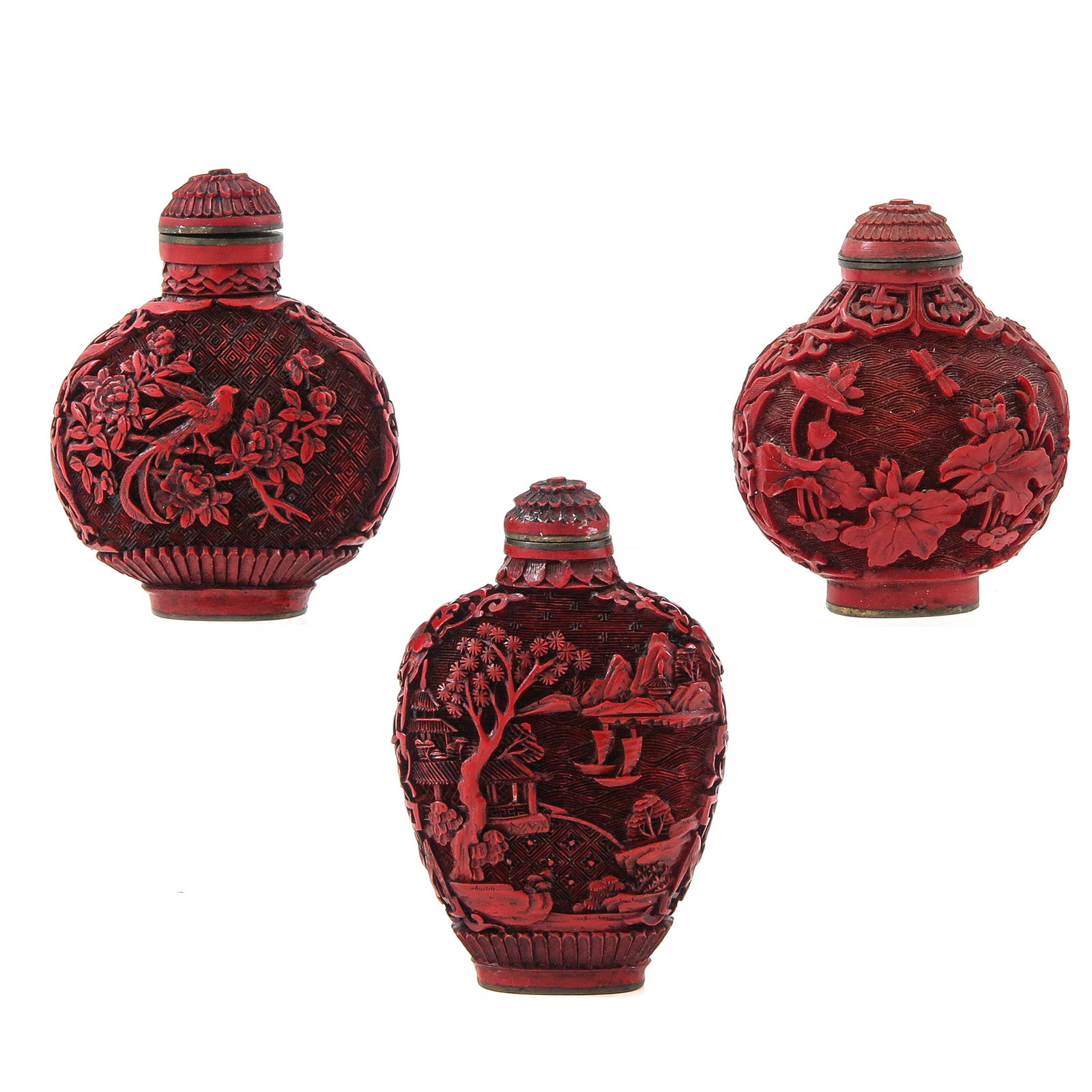 A Group of 3 Cinnabar Snuff Bottles: Depicting landscapes and floral decors, tallest snuff bottle is 7,5 cm.