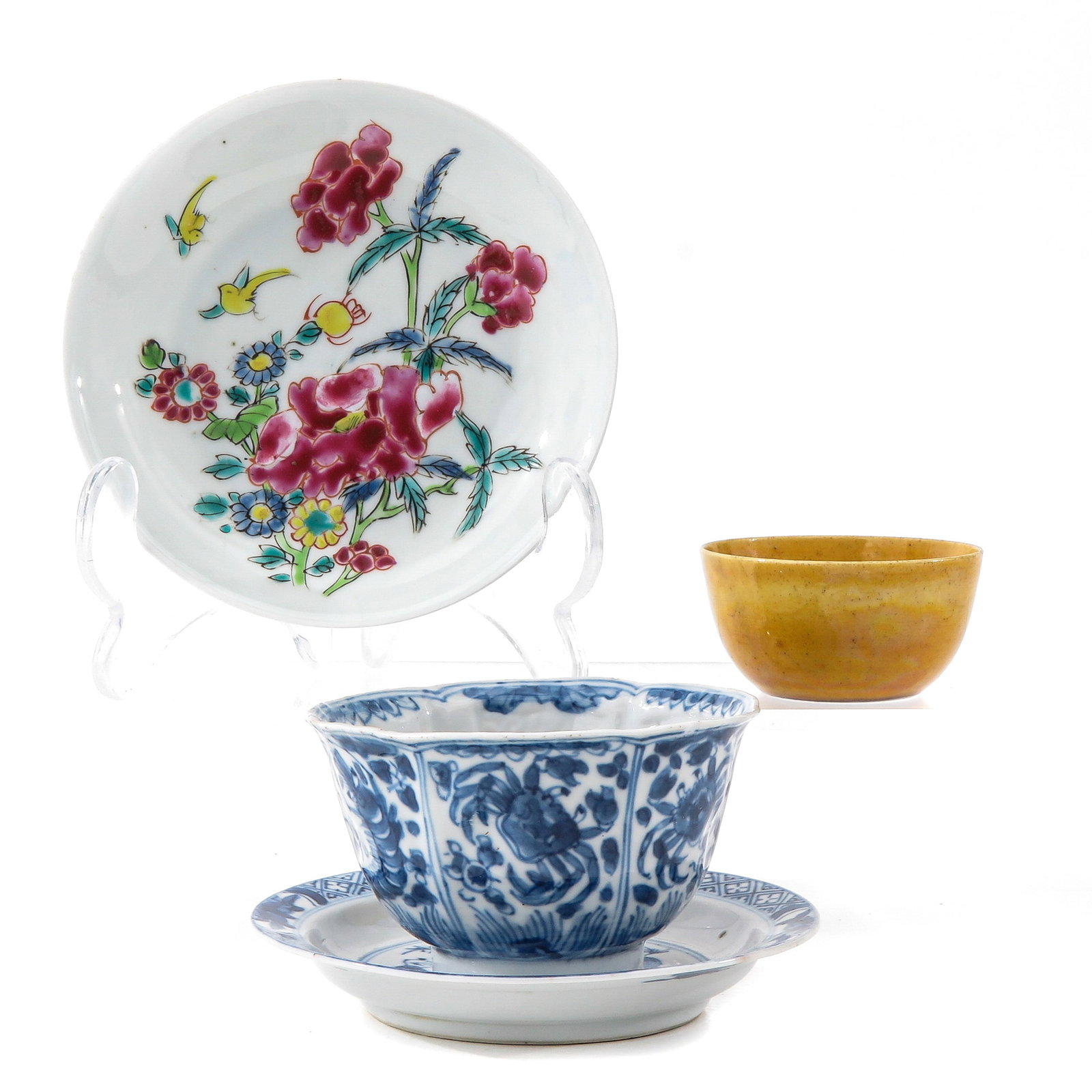 A Collection of Porcelain: Including 2 cups and 2 saucers, in a variety of decors, including Kangxi Period, largest saucer is 10 cm. in diameter, chip and hairline.