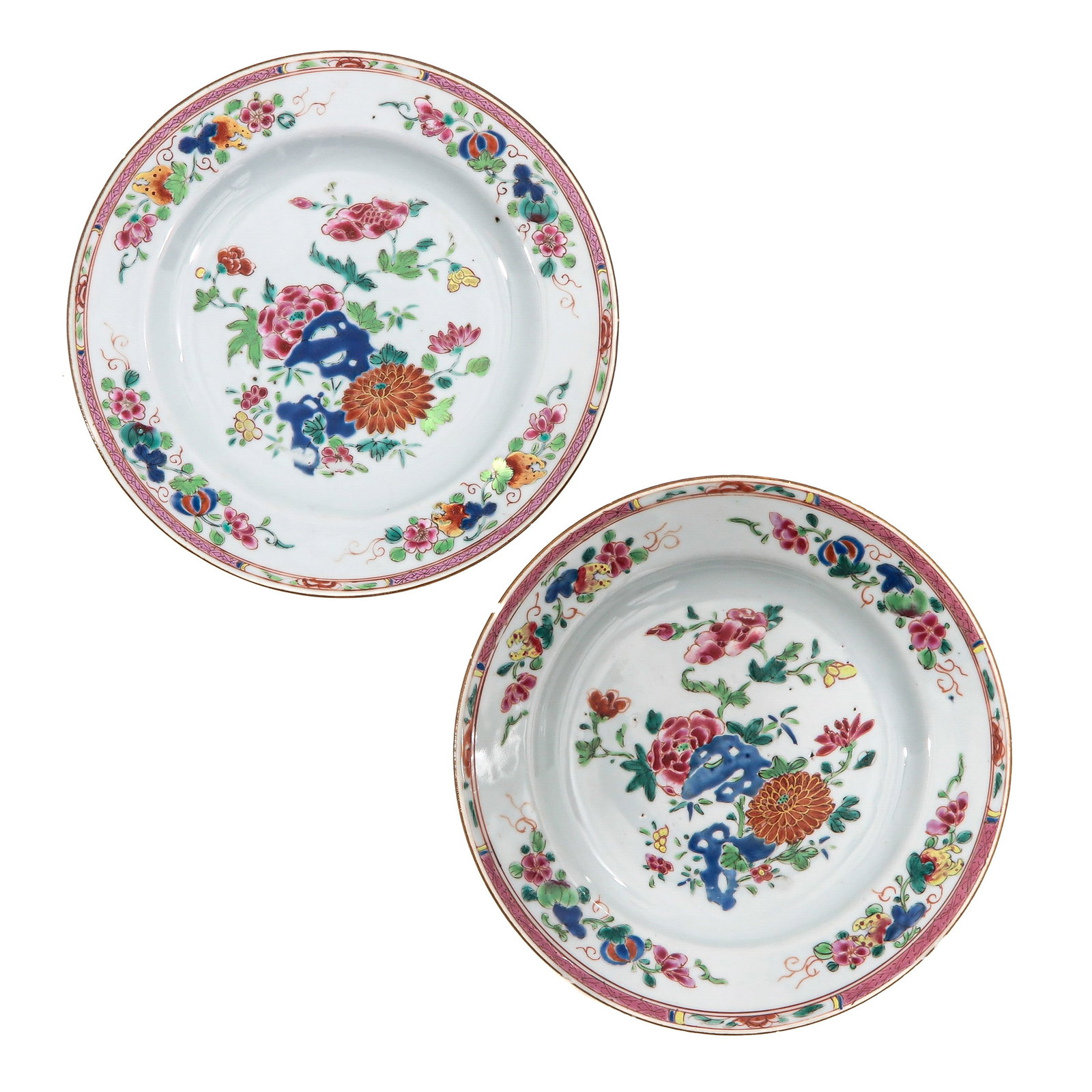 A Pair of Famille Rose Plates: Depicting a garden scene with flowers and rocks in Famille Rose enamels, 18th Century, 23 cm. in diameter, chip.