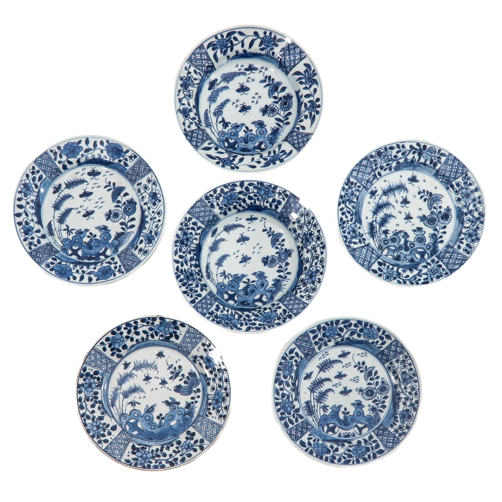 A Collection of 6 Blue and White Plates: In a variety of decors, 18th Century, 23 cm. in diameter, chip and hairline.