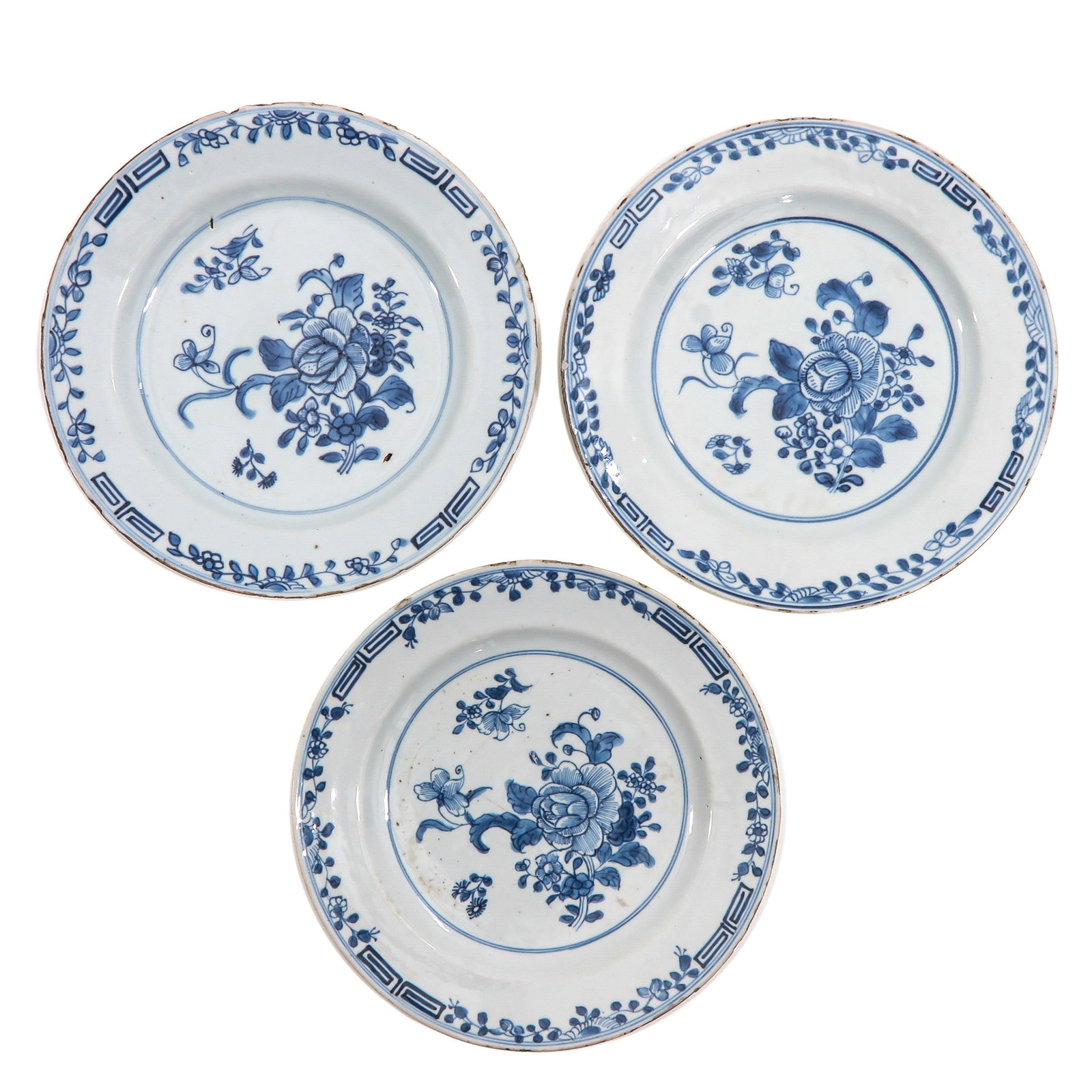 A Series of 3 Blue and White Plates: Depicting flowers in the center of the plates with scrolling floral decor on the border, 24 cm. in diameter, chip and hairline.