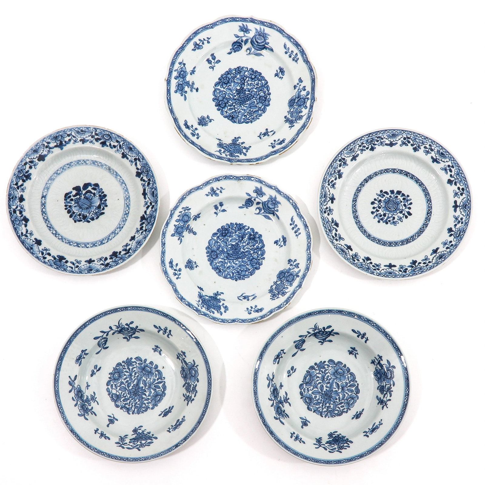 A Group of 6 Blue and White Plates: In a variety of decors, including 18th Century, 24 cm. in diameter, chip and hairline.
