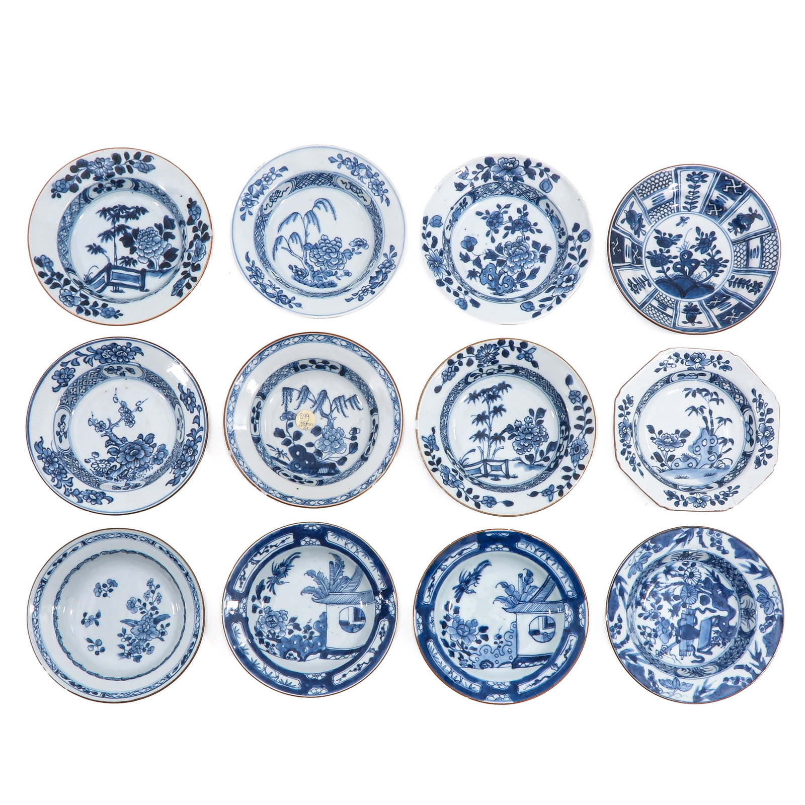 A Group of 12 Blue and White Plates: Depicting a variety of scenes, 18th Century, 16 cm. in diameter, chip and hairline.
