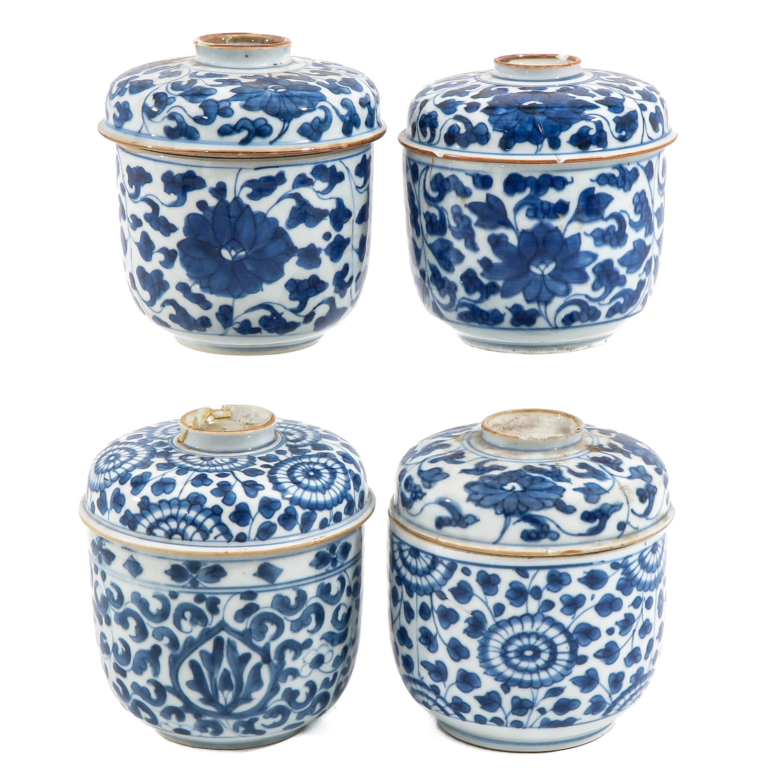 A Group of 4 Blue and White Jars with Covers: Scrolling floral decor, 18th Century, 12 cm. tall, in diverse conditions.