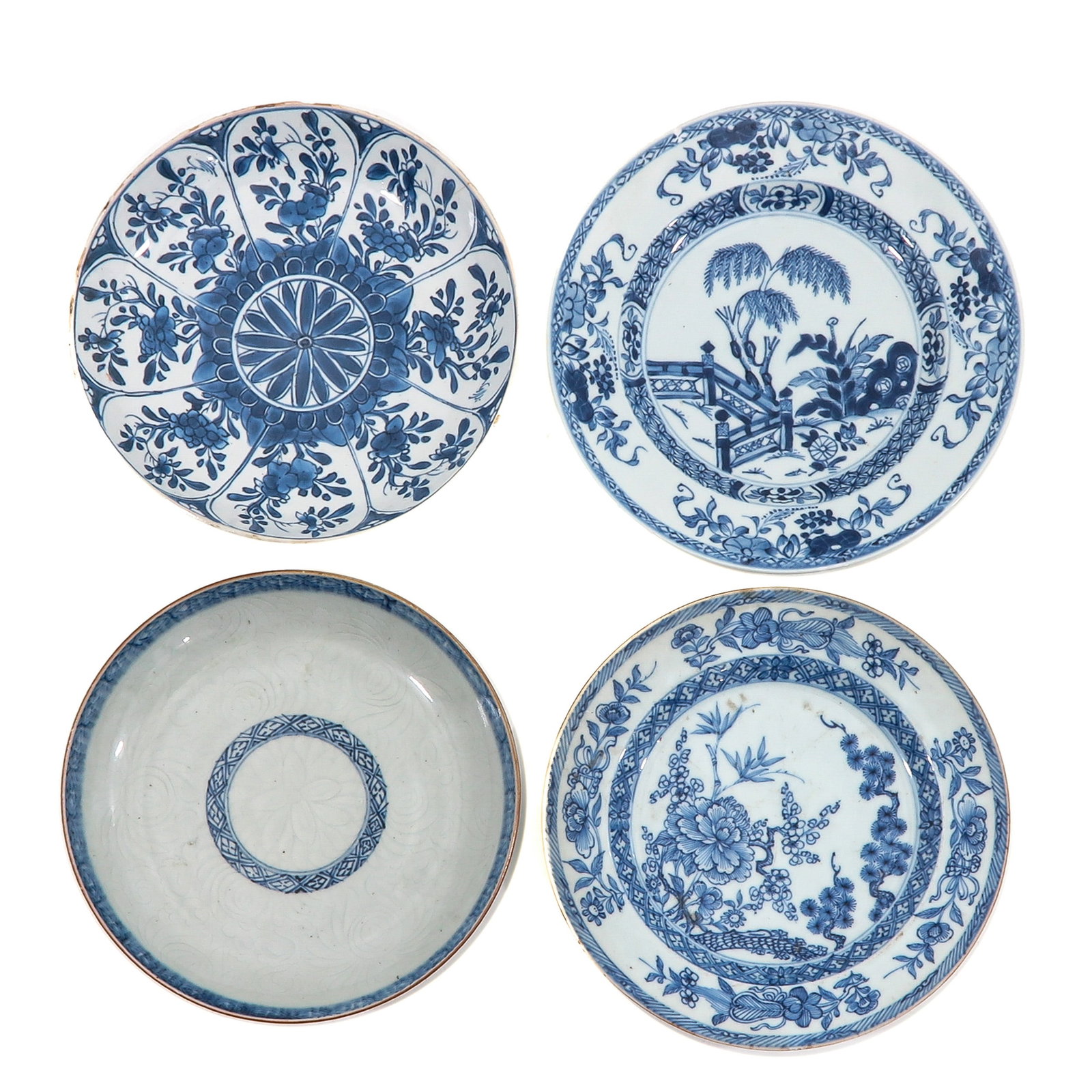 A Group of 4 Blue and White Plates: In a variety of decors, including 18th Century, largest plate is 23 cm. in diameter, chip and hairline.