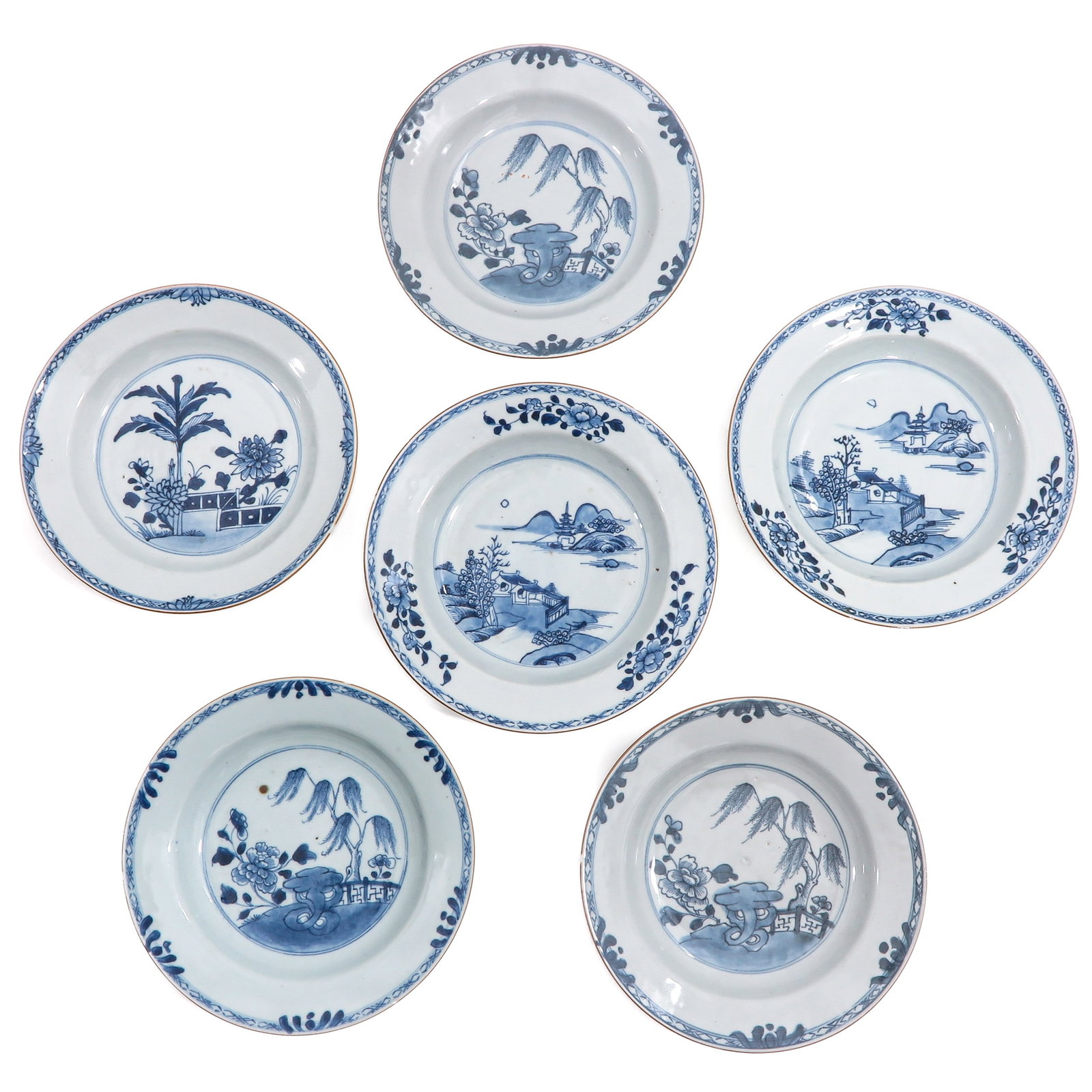 A Group of 6 Blue and White Plates: In a variety of decors, 18th Century, 23 cm. in diameter, chip and hairline.