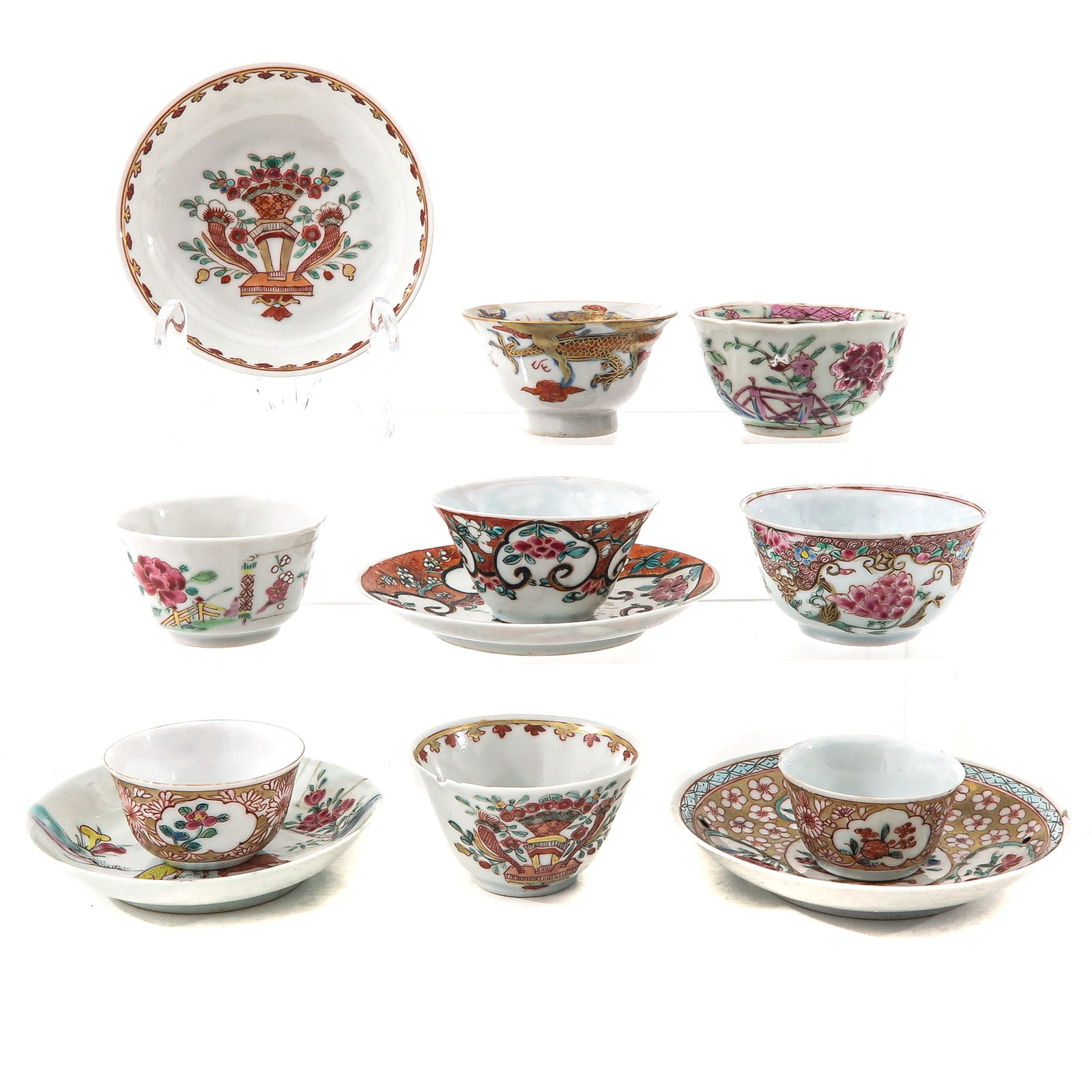 A Group of Cups and Saucers: Including 8 cups and 4 saucers in a variety of Famille Rose decors, largest saucer is 11 cm. in diameter, in diverse conditions.