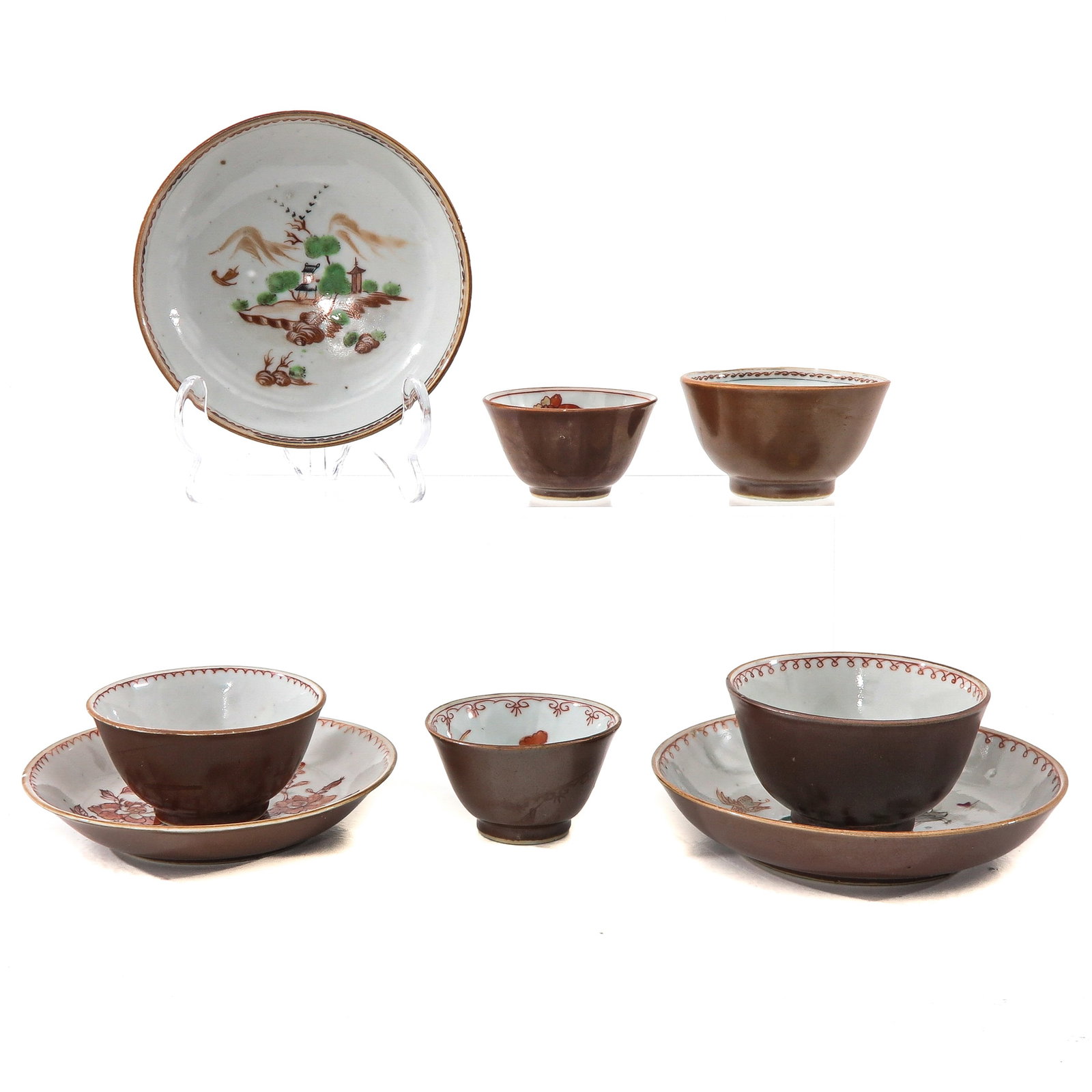 A Group of Batavianware Cups and Saucers: Including 5 cups and 3 saucers, in a variety of decors, 18th Century, largest saucer is 13 cm. in diameter, chip and hairline.