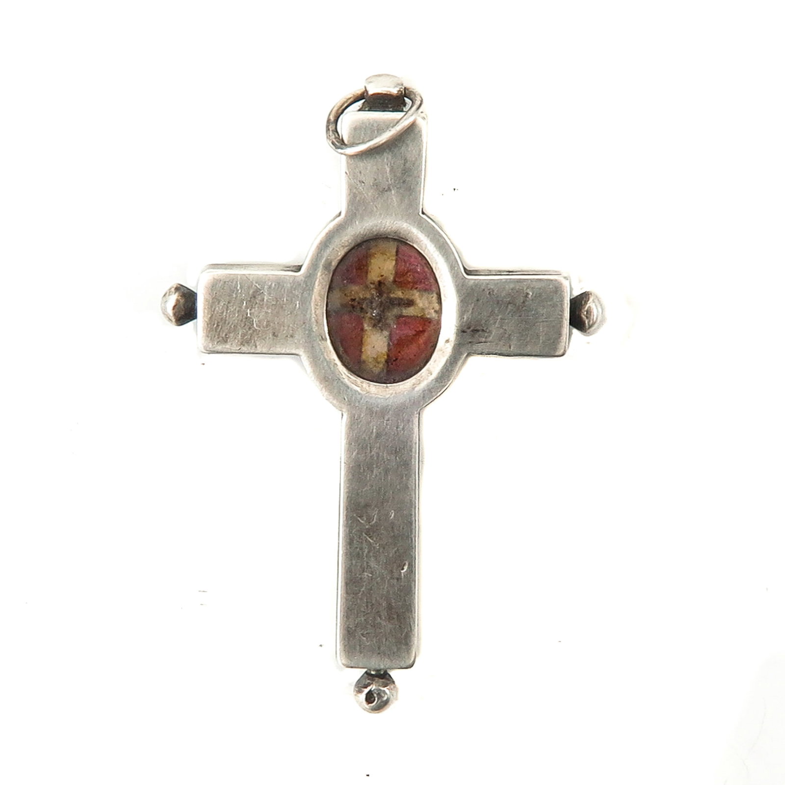 A Relic Pendant: Silver, in the shape of a cross, containing a relic of the Holy Cross, length 4.5 cm. You are purchasing the theca; the relics are a gift.