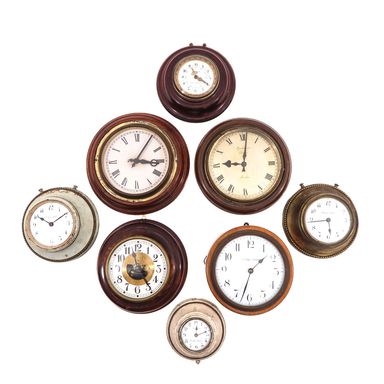 A Group of 8 Electric Wall Clocks: Consisting of eight electric wall clocks, including one by Paul Garnier, largest diameter 26 cm.