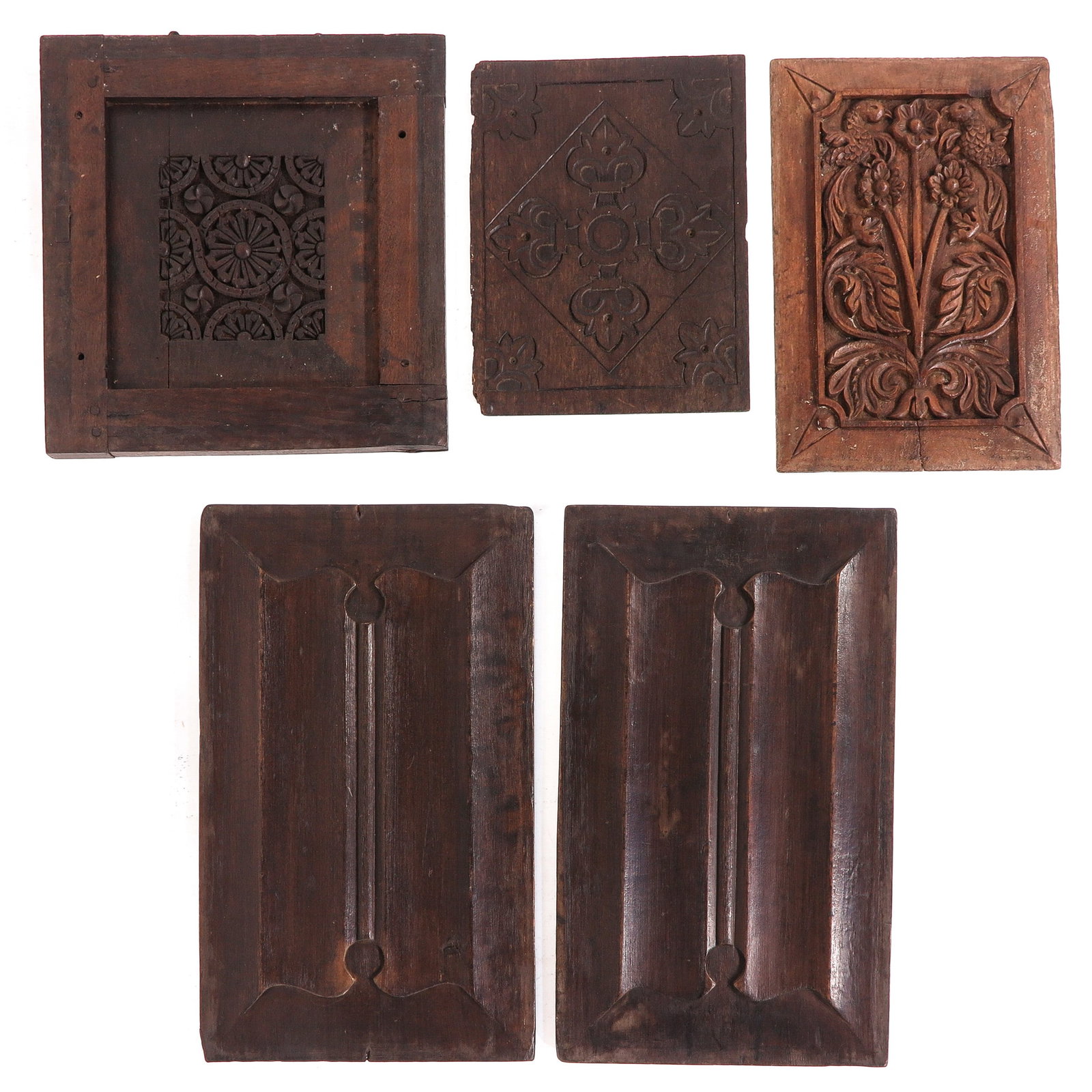 A Group of 5 Carved Wood Panels: Consisting of 5 carved wooden panels, largest 40 x 42 cm.