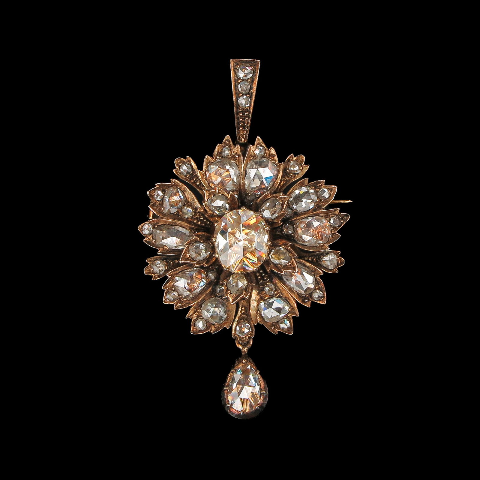 A Diamond Brooch: Gold on silver, set with rose-cut diamonds, the largest central diamond approx. 7 x 9mm, with a pear-shaped diamond approx. 5 x 7mm, total length 43mm.