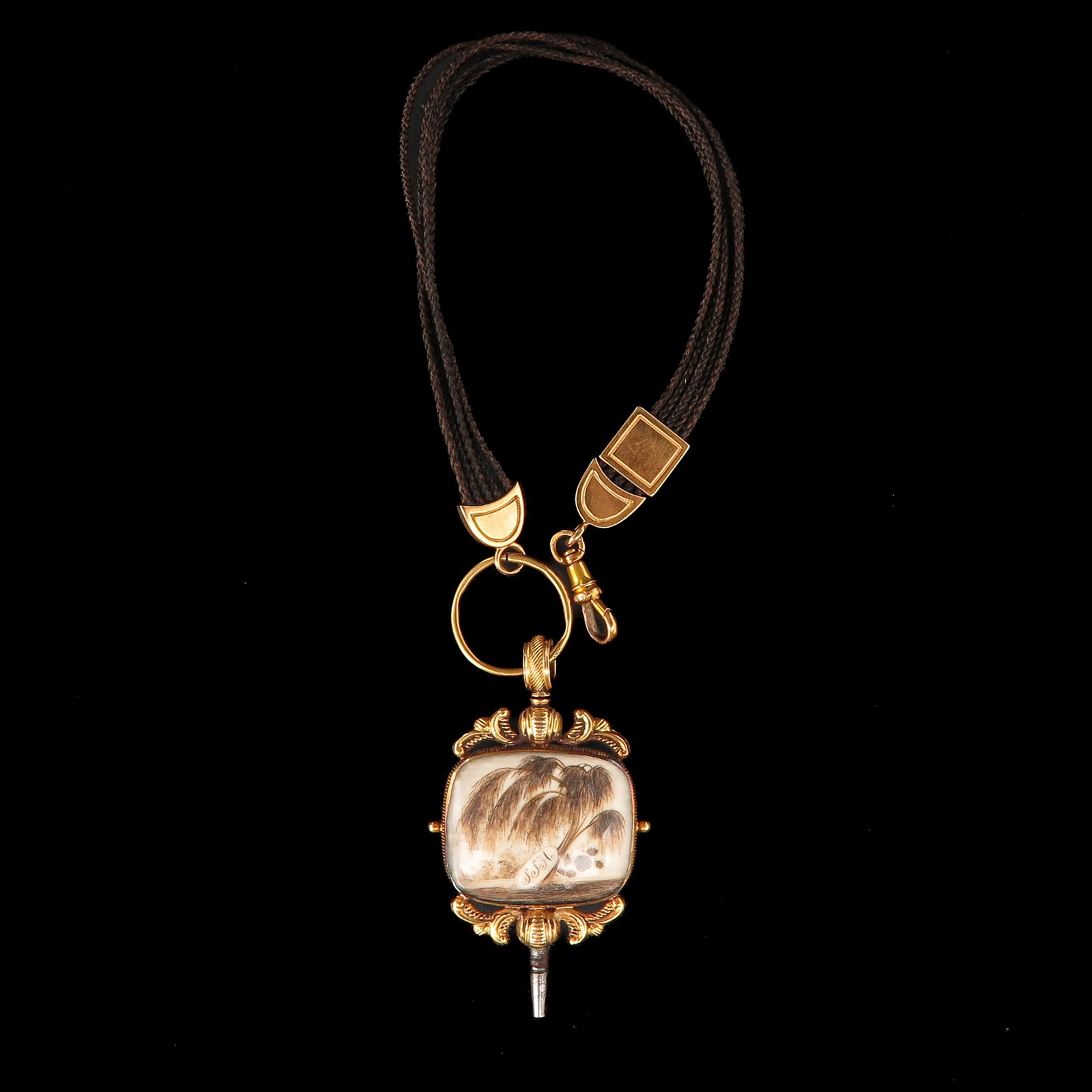 A Watch Chain Made of Hair with 14KG: With watch key, made of hair, 14 carat gold mounts, length 28 cm.