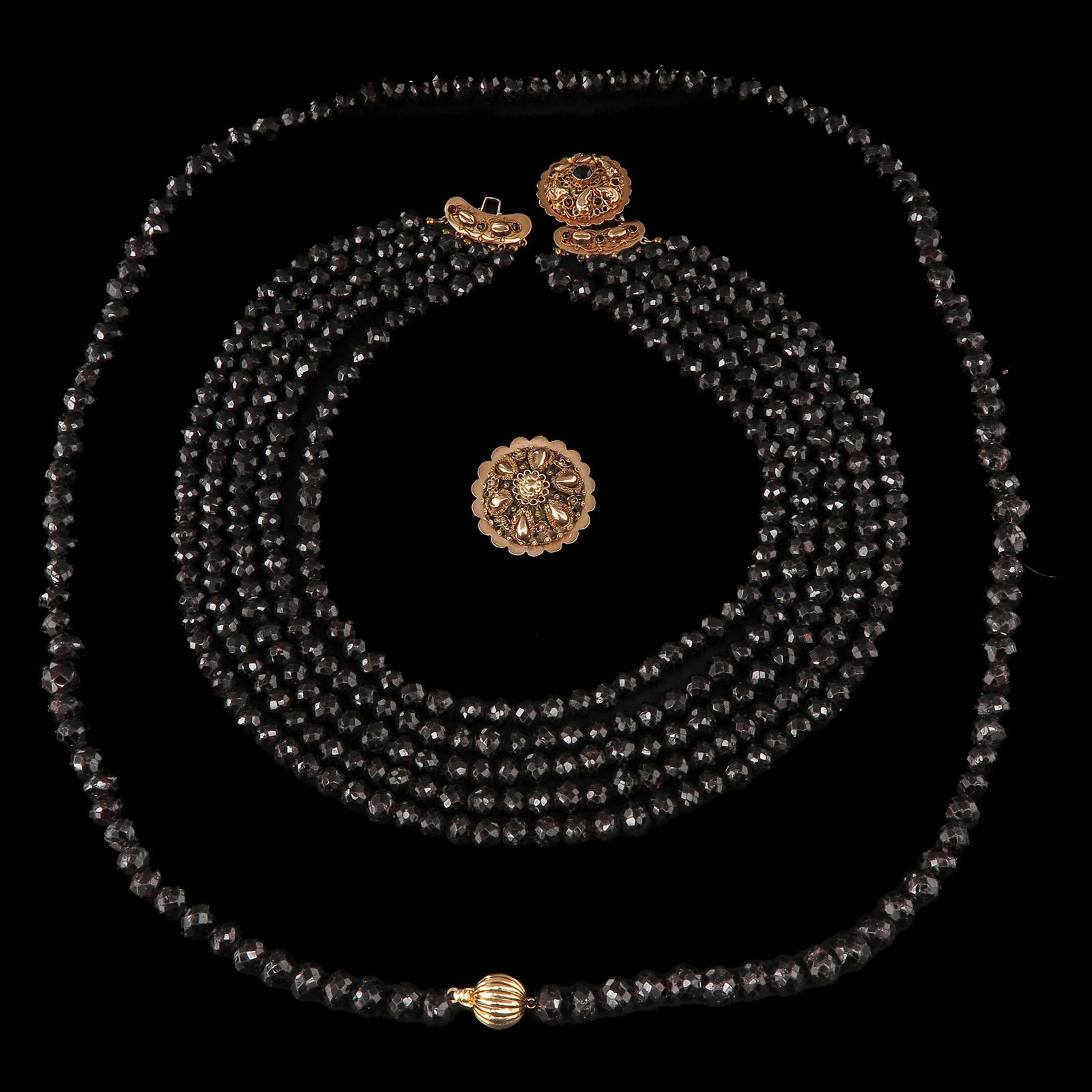 A Lot of 2 Garnet Necklaces: Consisting of two garnet necklaces with 14-karat gold clasps.