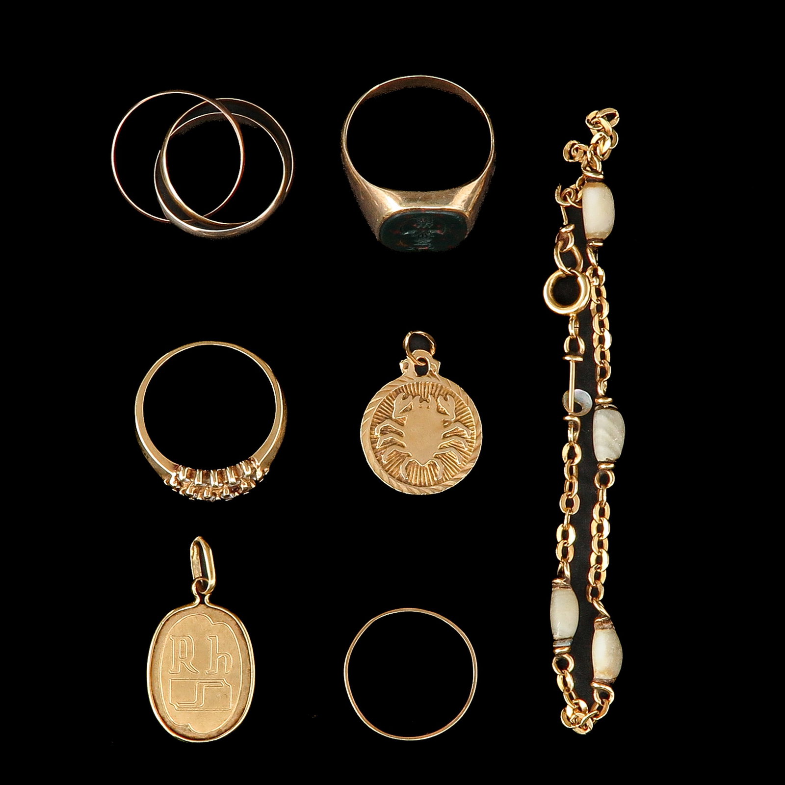 A Group of Jewelry: Gold jewelry consisting of two pendants, a bracelet, and four rings, one of which is a signet ring with a coat of arms, ring size 20.