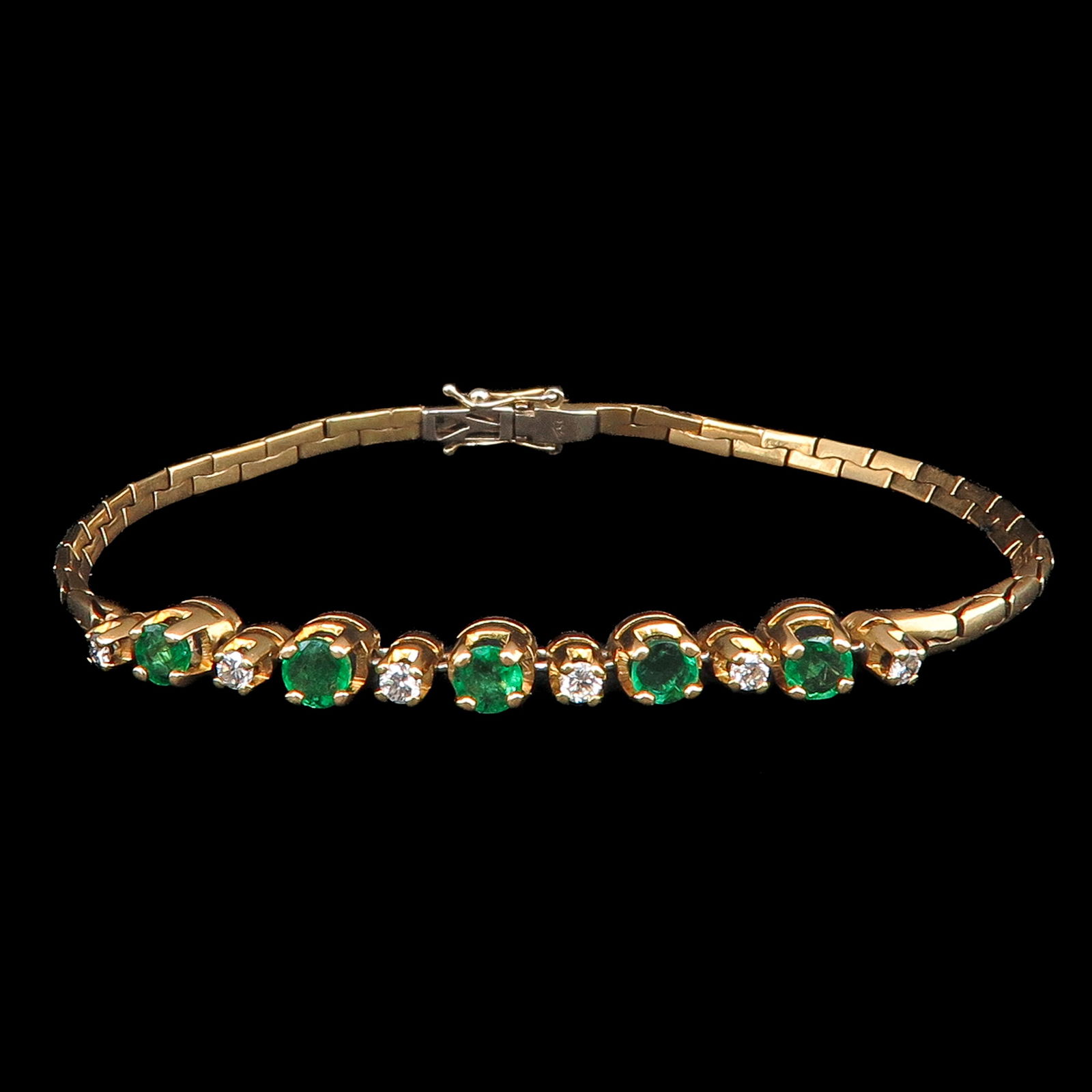 An 18KG Emerald and Diamond Bracelet: 18 carat gold, set with 5 emeralds, diameter 4 mm, and 6 brilliant-cut diamonds, length 18.5 cm.