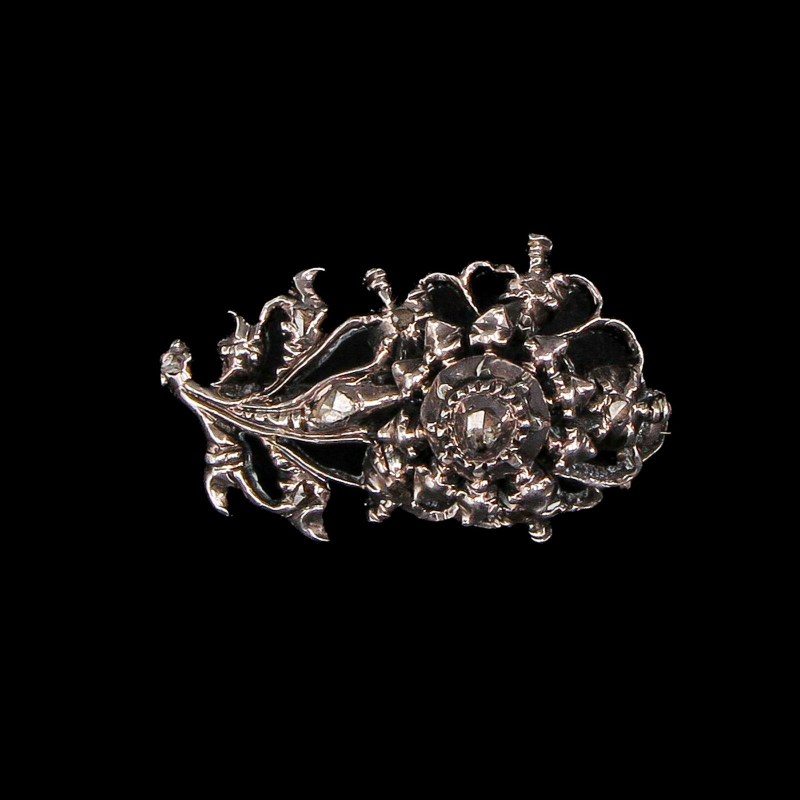 A Diamond Brooch: Silver, set with rose-cut diamonds, 26 mm long.