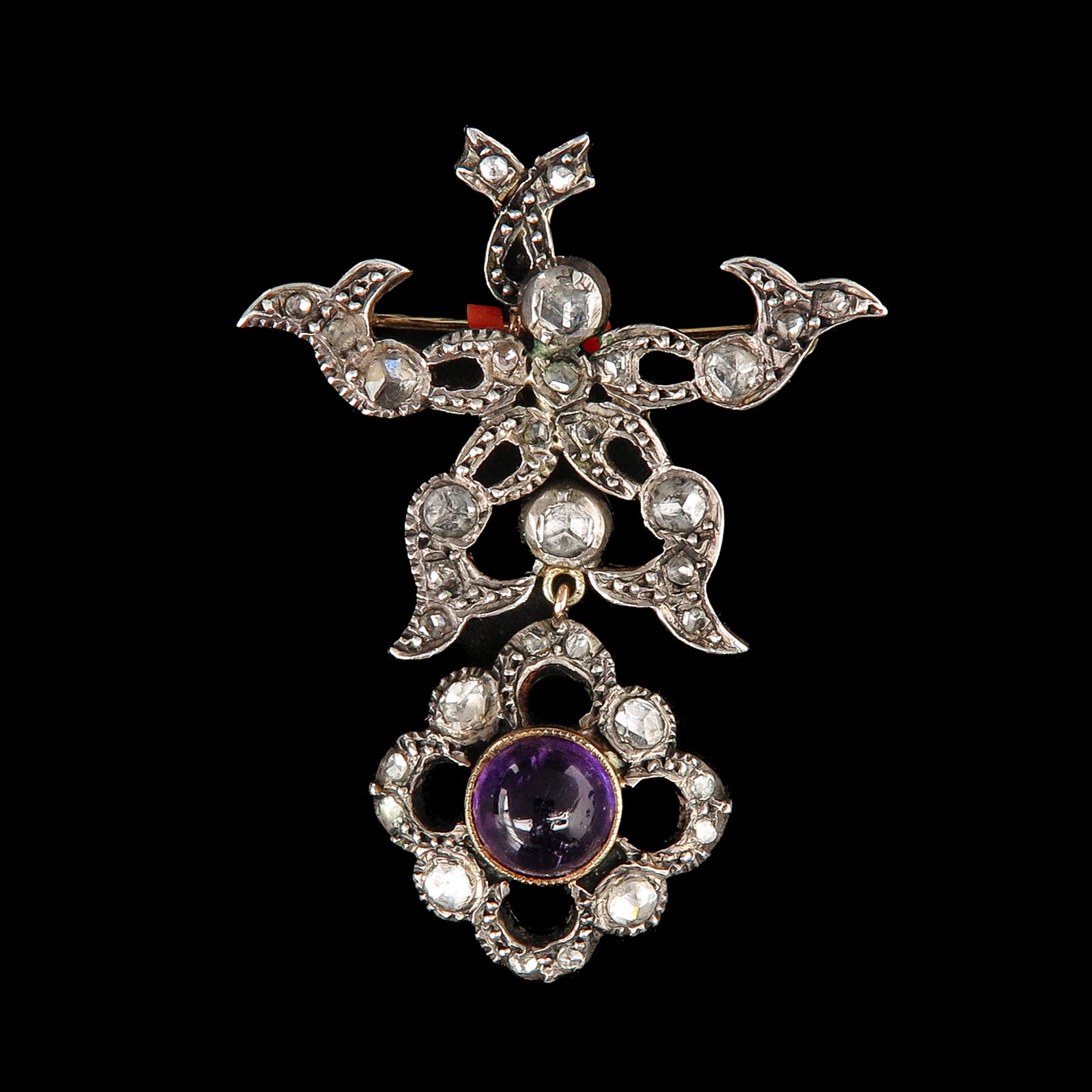 A Diamond Brooch/Pendant: Silver on gold, set with rose-cut diamonds and a cabochon-cut amethyst, length 47 mm.