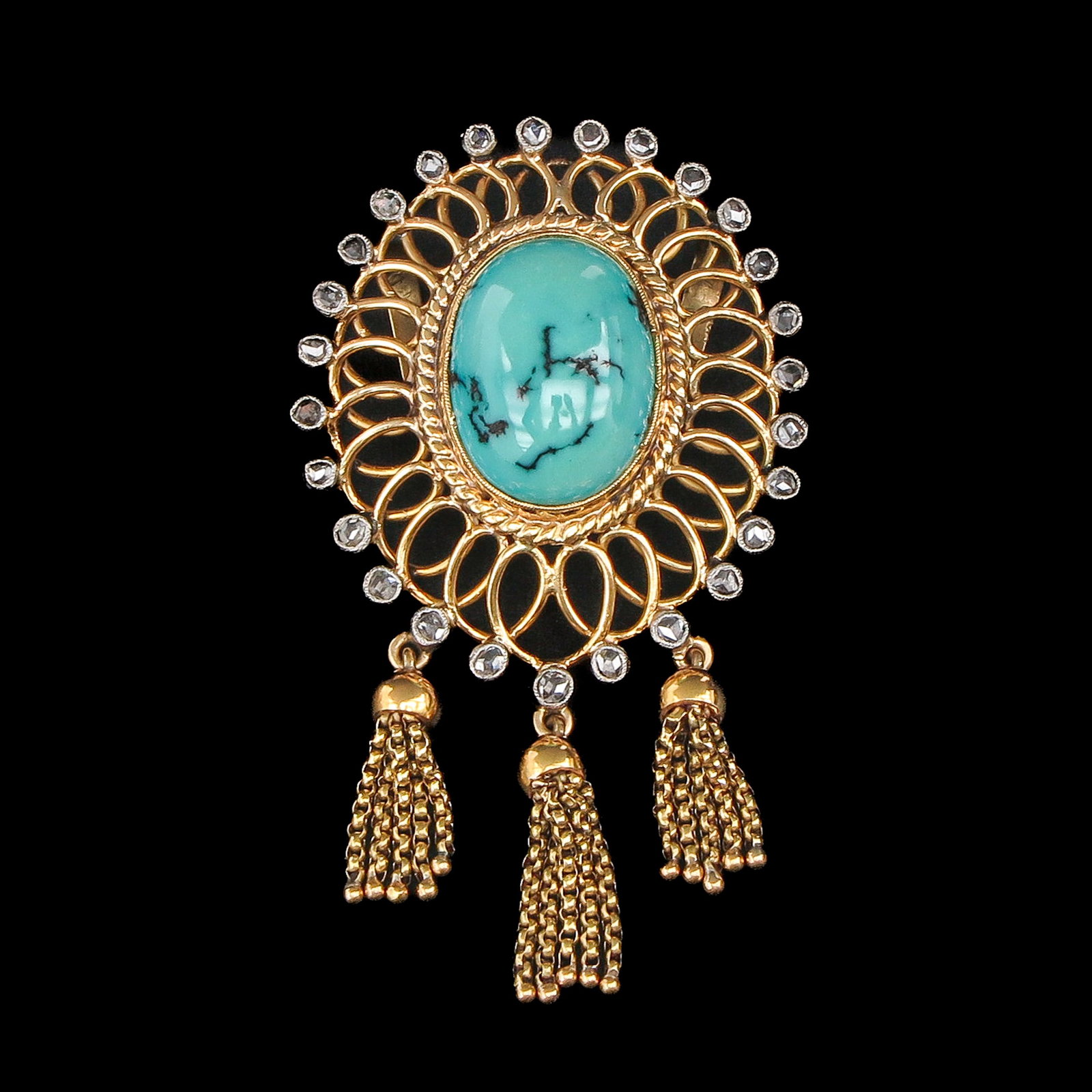 A Turquoise and Diamond Brooch: Gold and silver, set with a cabochon-cut turquoise and rose-cut diamonds, length 50 mm.