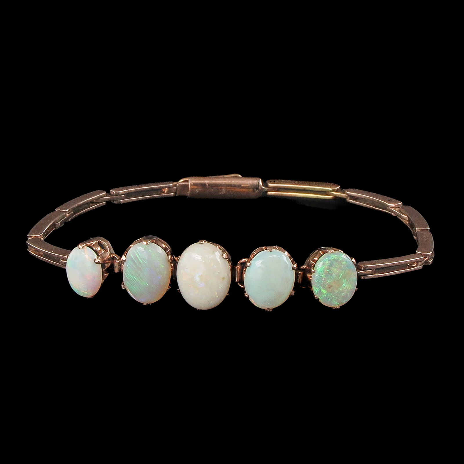 An Opal Bracelet: 9 carat gold, set with 5 opals, largest 9 x 11 mm, length 17 cm.