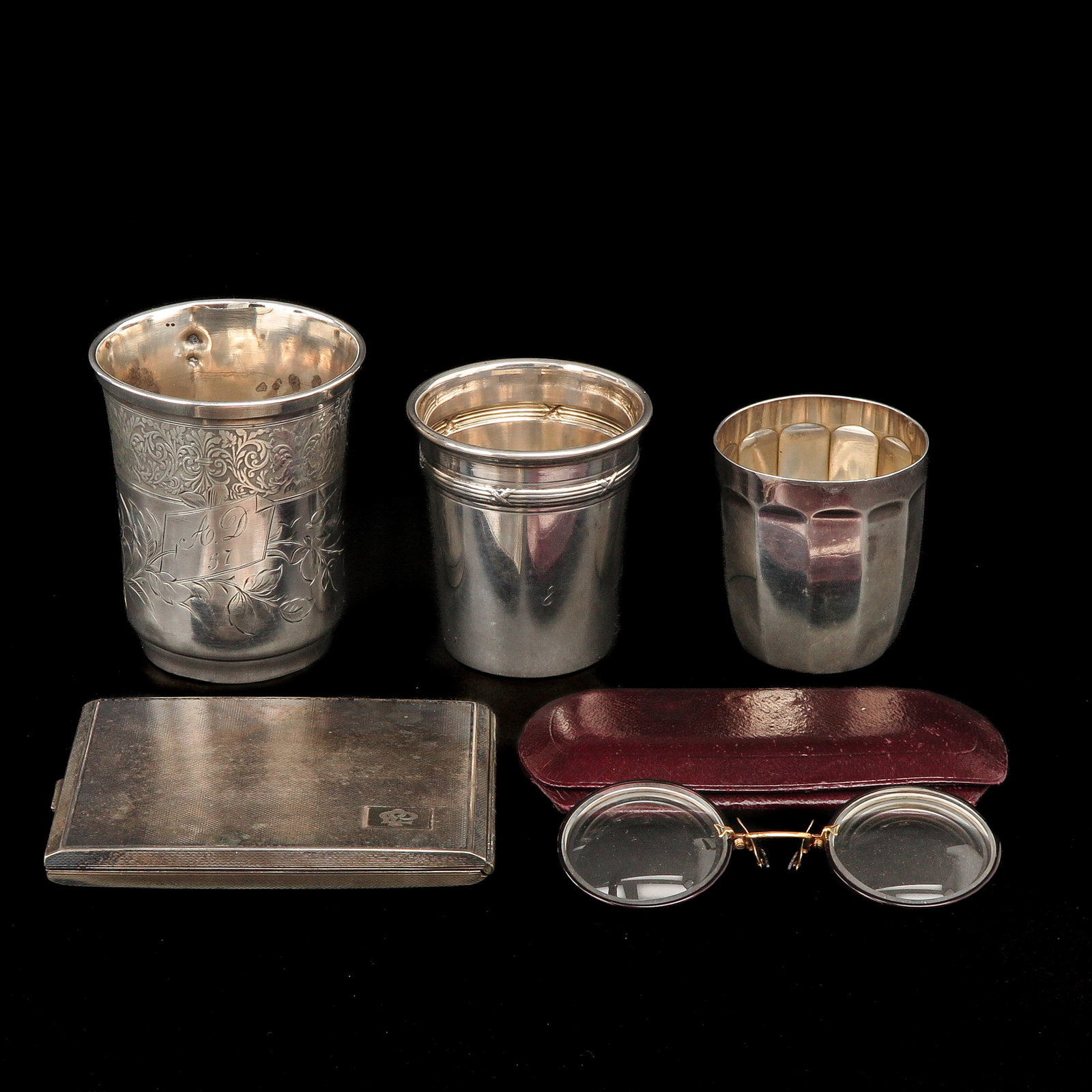A Diverse Collection of Items: Consisting of 3 silver cups, a cigarette holder, and glasses, height 9 cm.