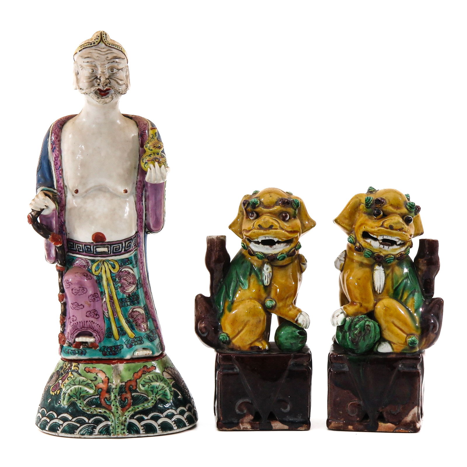 A Group of Sculptures: Including a Chinese figure on base and a pair of temple lions, figure is 30 cm. tall, chip.