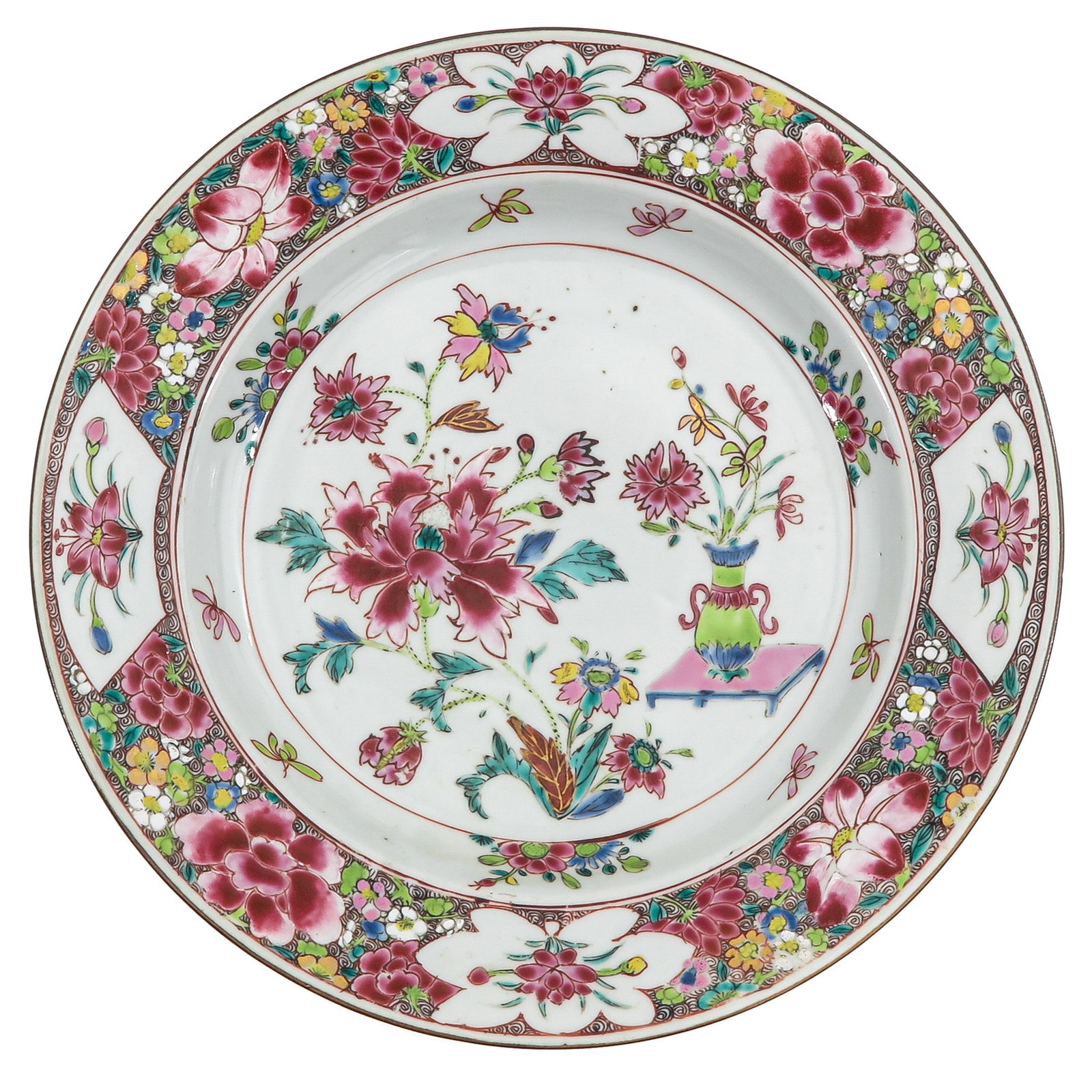 A Famille Rose Plate: Floral scene with a vase filled with flowers sitting on a table, 18th Century, 29 cm. in diameter.