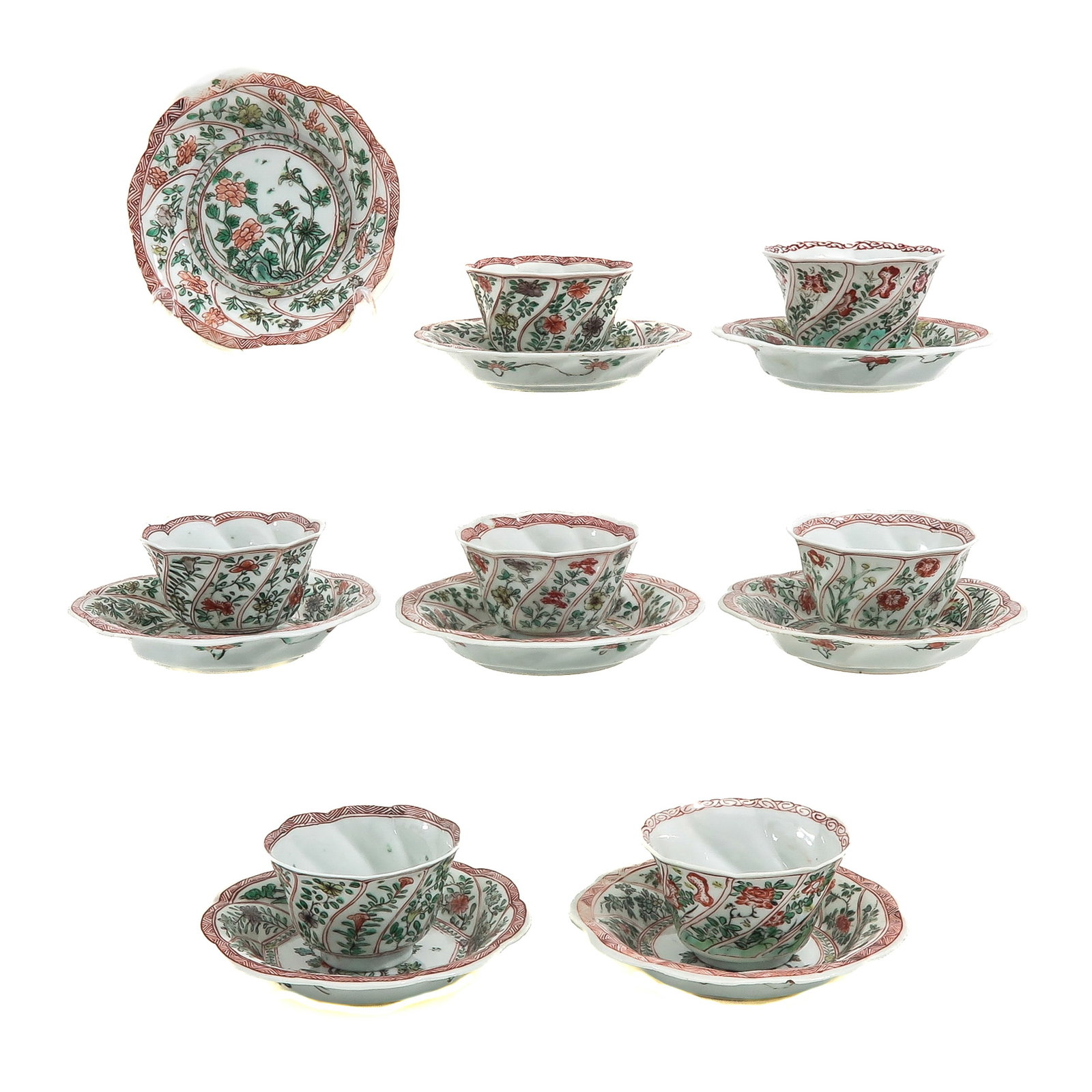 A Group of Cups and Saucers: Including 7 cups and 8 saucers in Famille Verte floral decor, 18th Century, saucers are 13 cm. in diameter, chip and hairline.