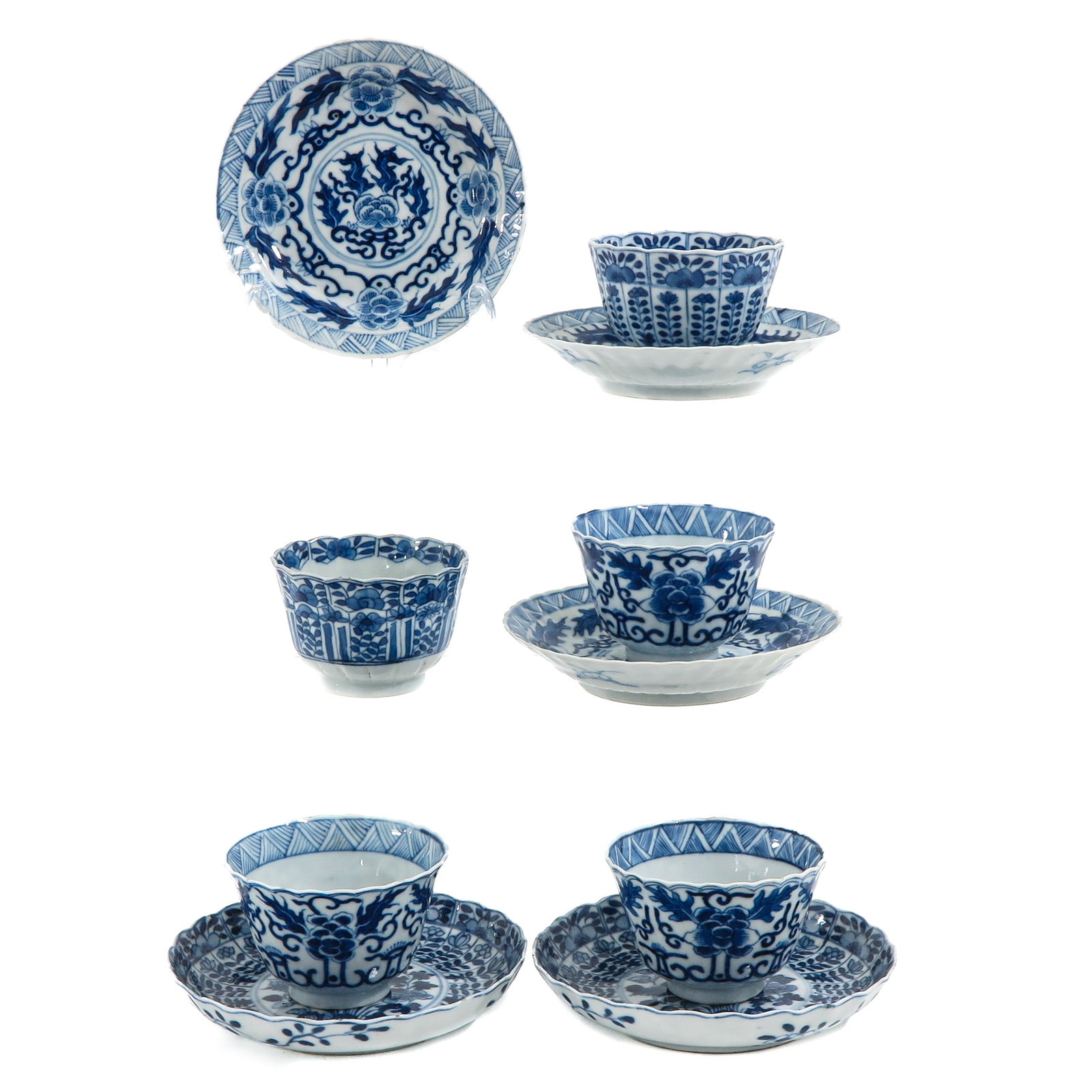 A Collection of Cups and Saucers: Including 5 cups and 5 saucers in blue and white floral deocrs, including 18th Century, saucers are 13 cm. in diameter, chip and hairline.