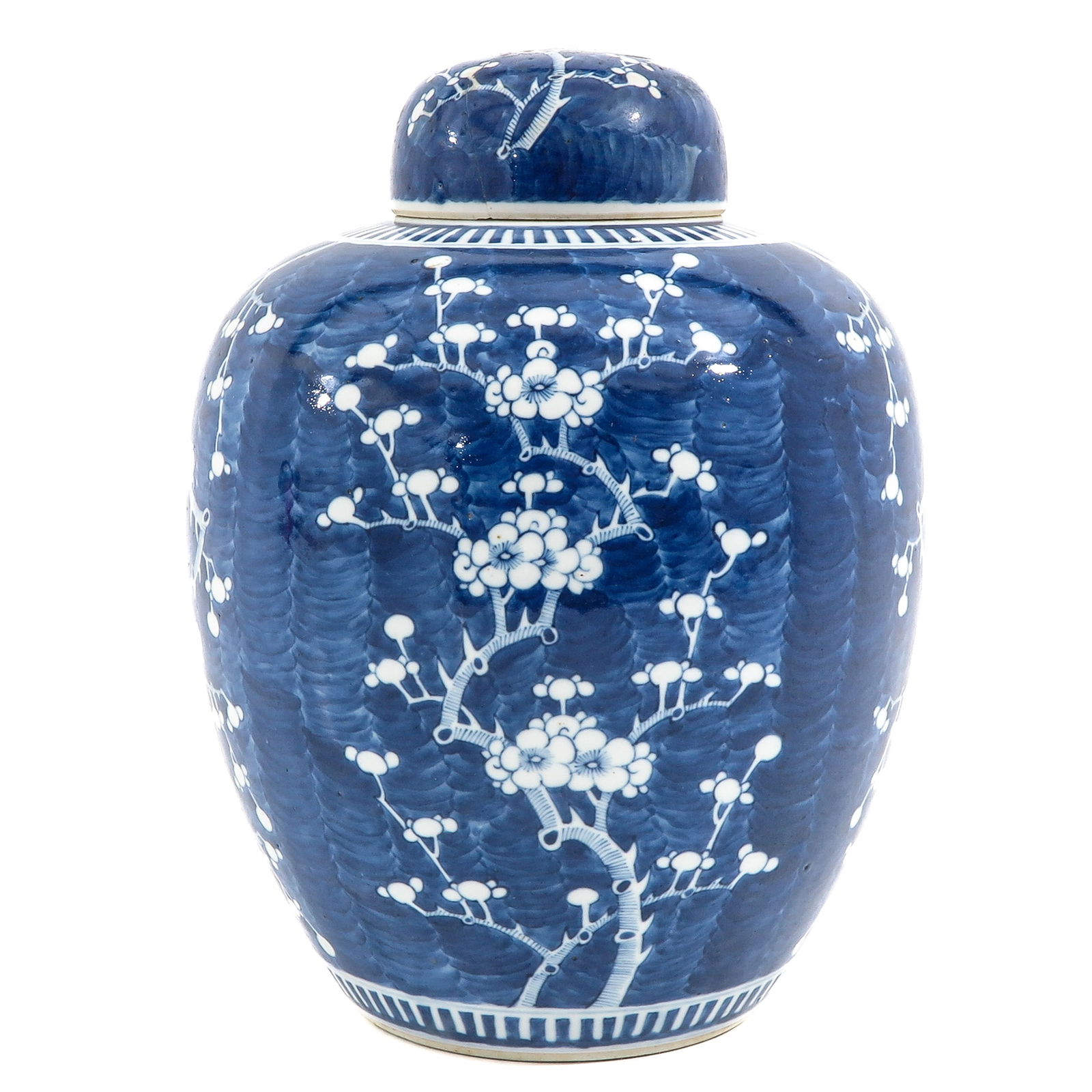 A BLue and White Ginger Jar: Dark blue ground with white flower blossom decor, 19th Century, 34 cm. tall, cover is restored.