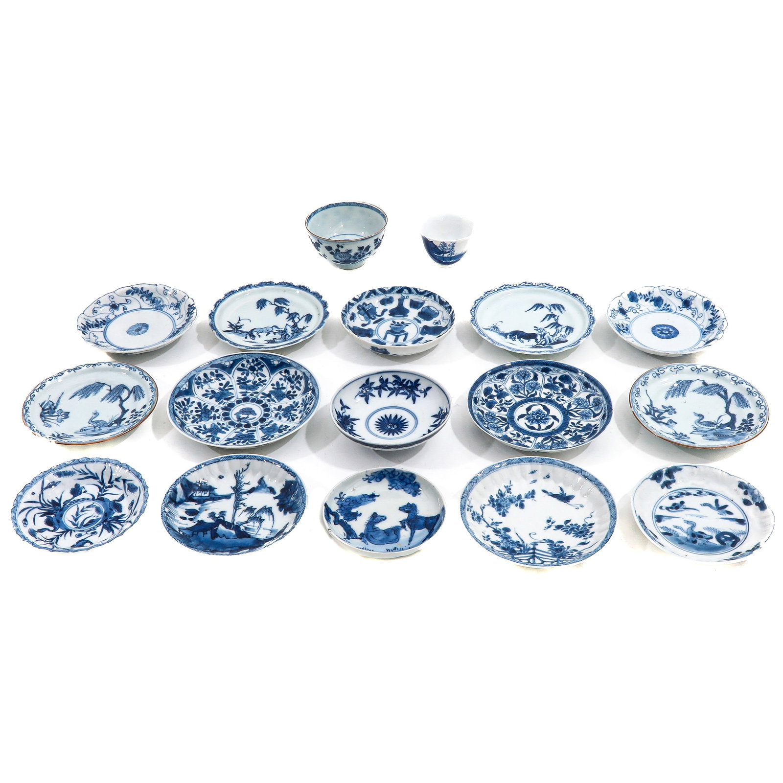 A Group of Cups and Saucers: In a variety of blue and white decors, including 18th Century, largest saucer is 13 cm. in diameter, chip and hairline.