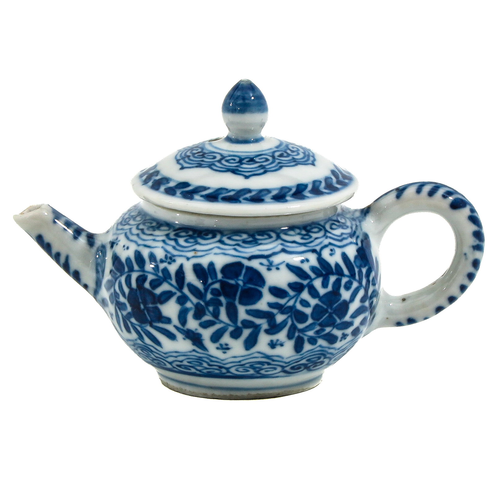 A Miniature Blue and White Teapot: Floral decor, 18th Century, 7 cm. tall, chip and hairline.