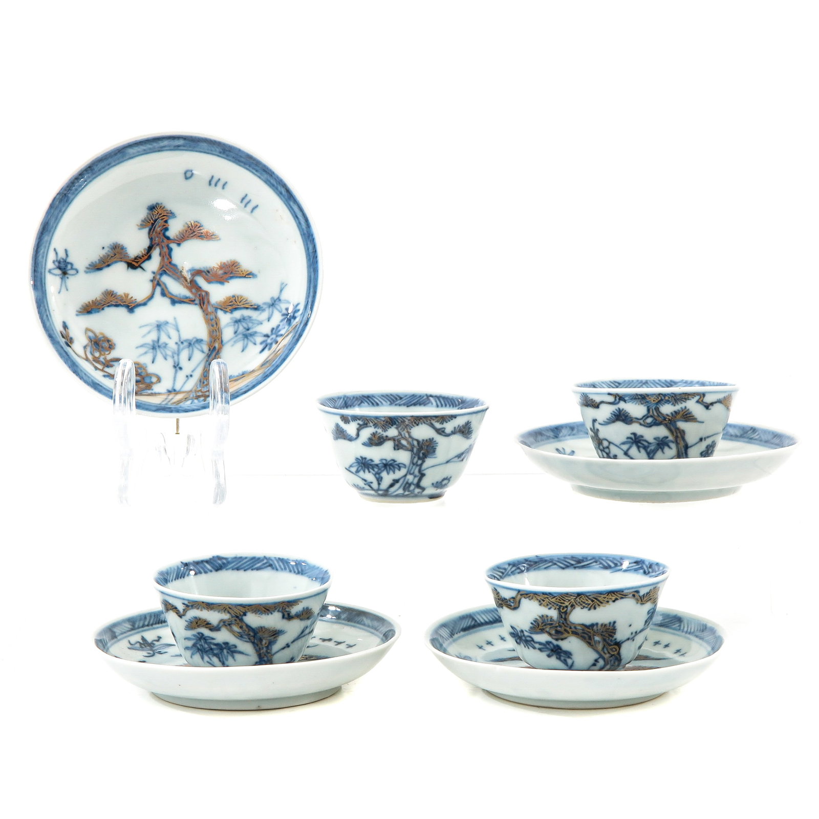 A Set of 4 Cups and Saucers: Landscap decor in blue and gilt enamels, saucers are 9 cm. in diameter, chip and hairline.