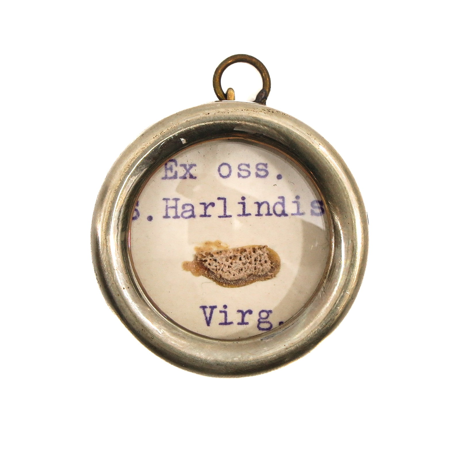 A Sealed Theca: Containing a bone relic of Saint Harlindis (virgin, first abbess of Aldeneik), diameter 4 cm., with certificate. You are purchasing the theca; the relics are a gift.